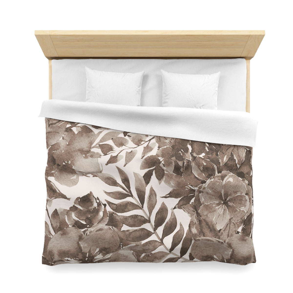 a neatly made bed with a floral print duvet cover and two white pillows.