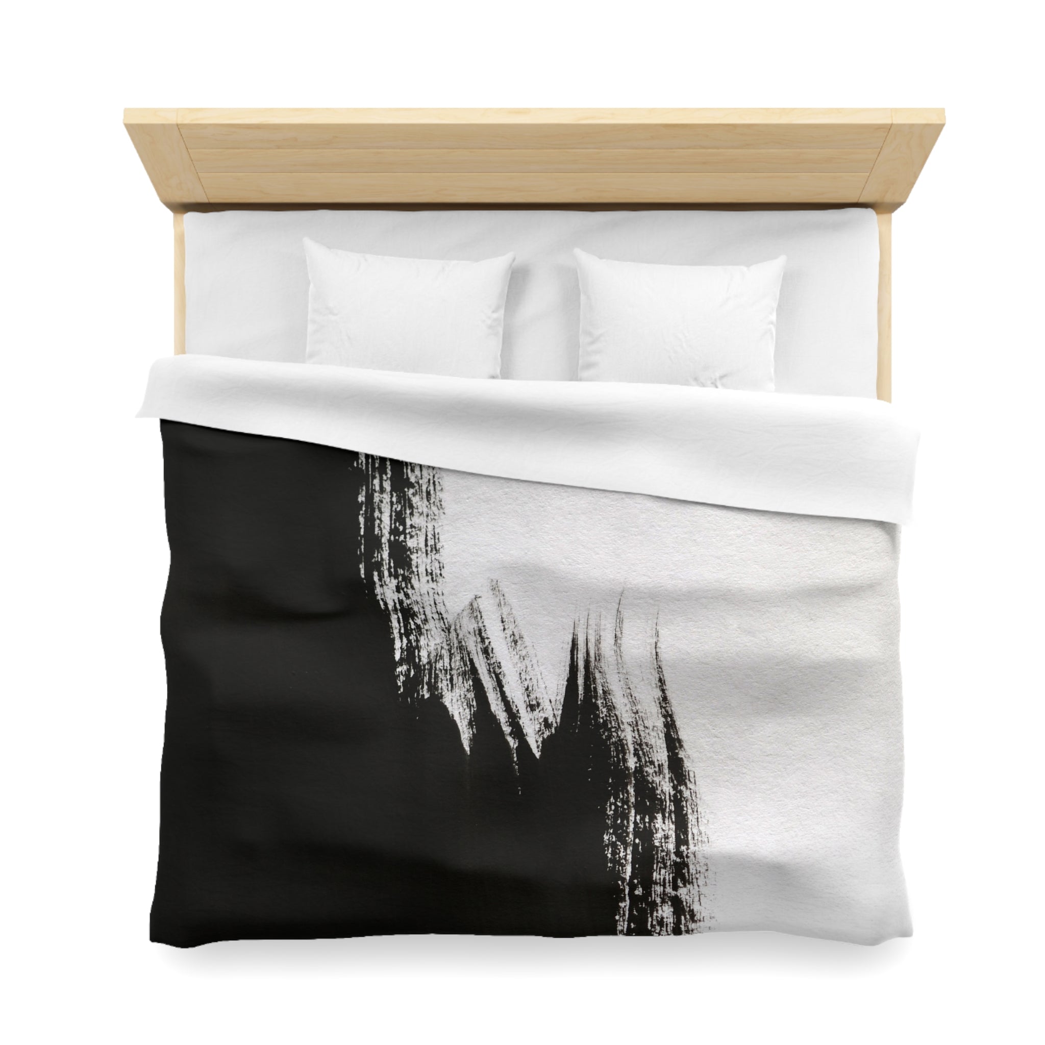 a neatly made bed with a black and white comforter and two white pillows.