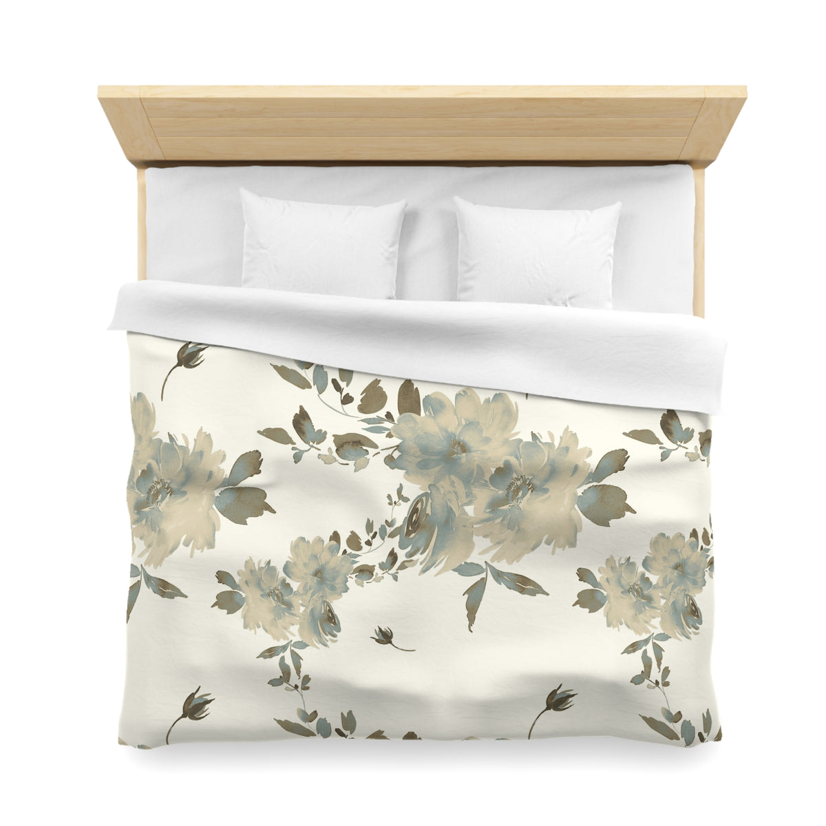 a neatly made bed with a floral print comforter and pillows.