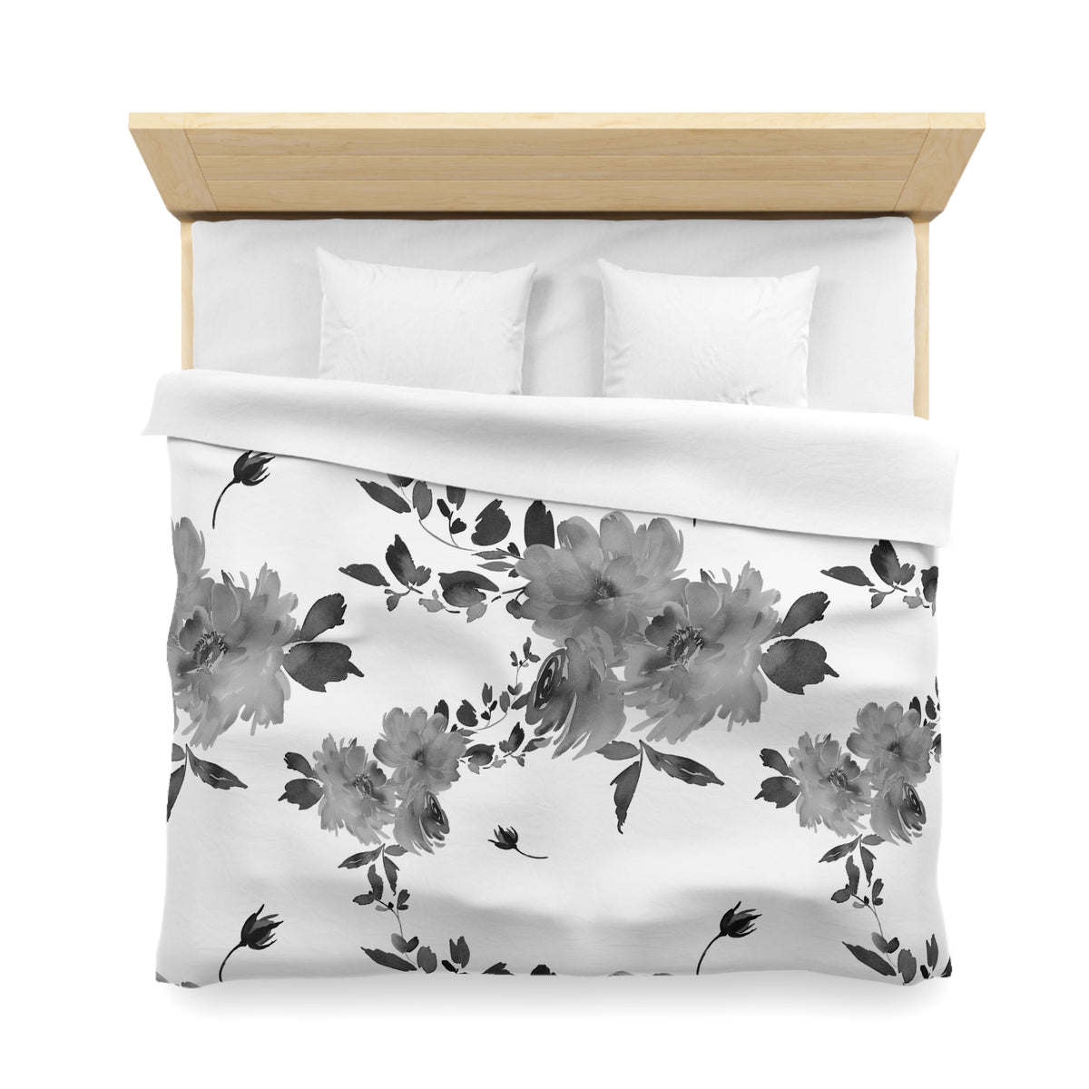 a neatly made bed with a floral print duvet cover and two white pillows.