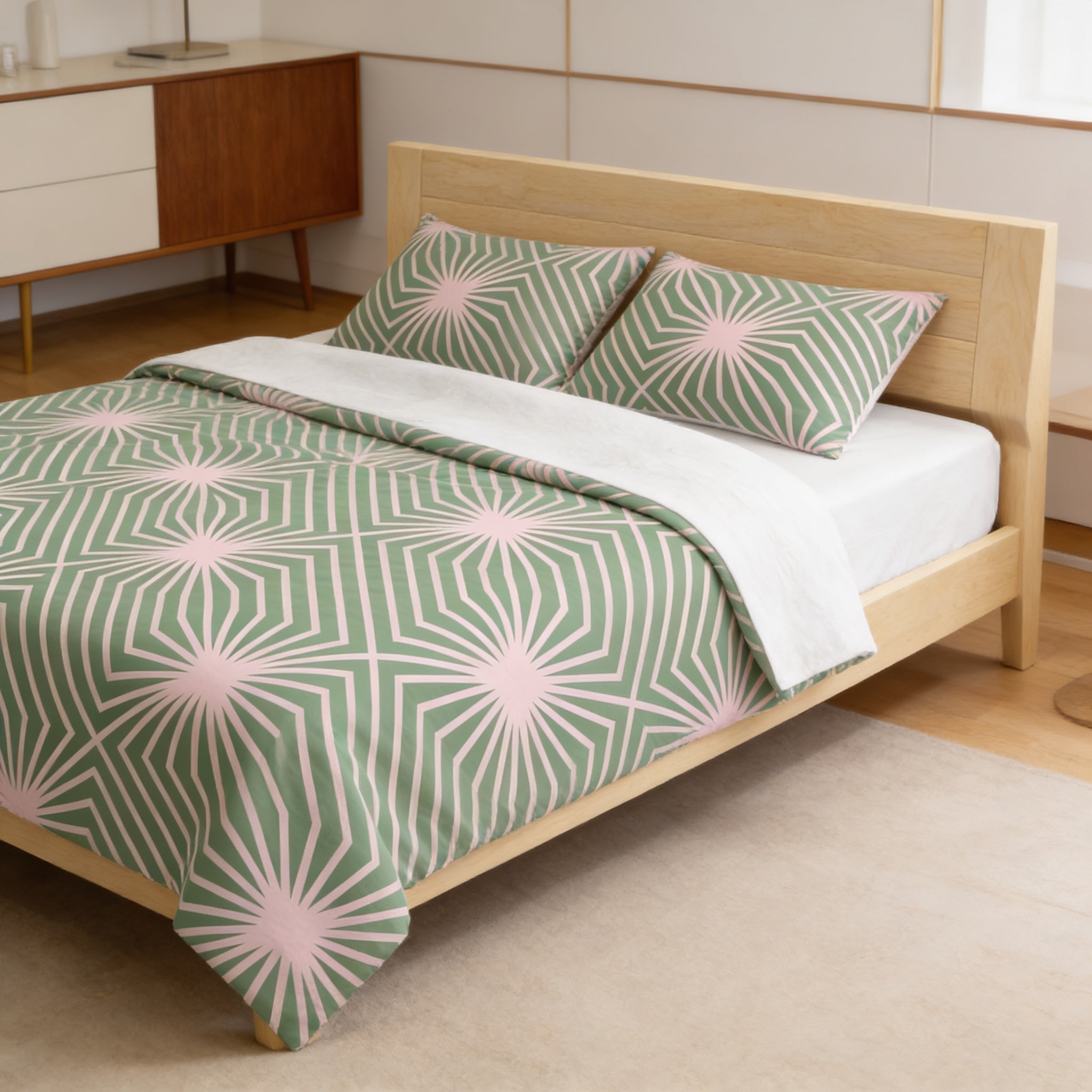 a modern bedroom with a wooden bed frame and a green and white geometric patterned comforter.