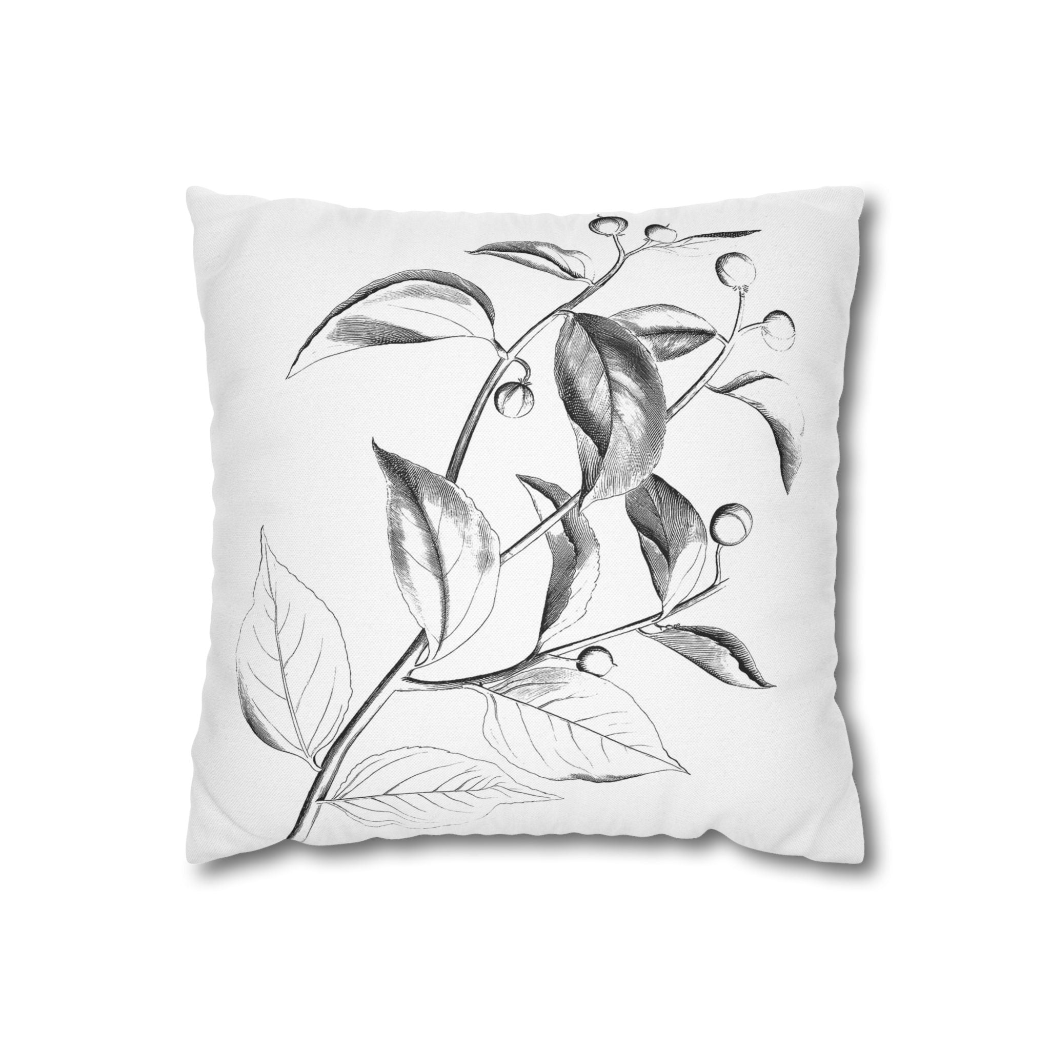 A square pillow with a black and white illustration of leaves and berries on it.