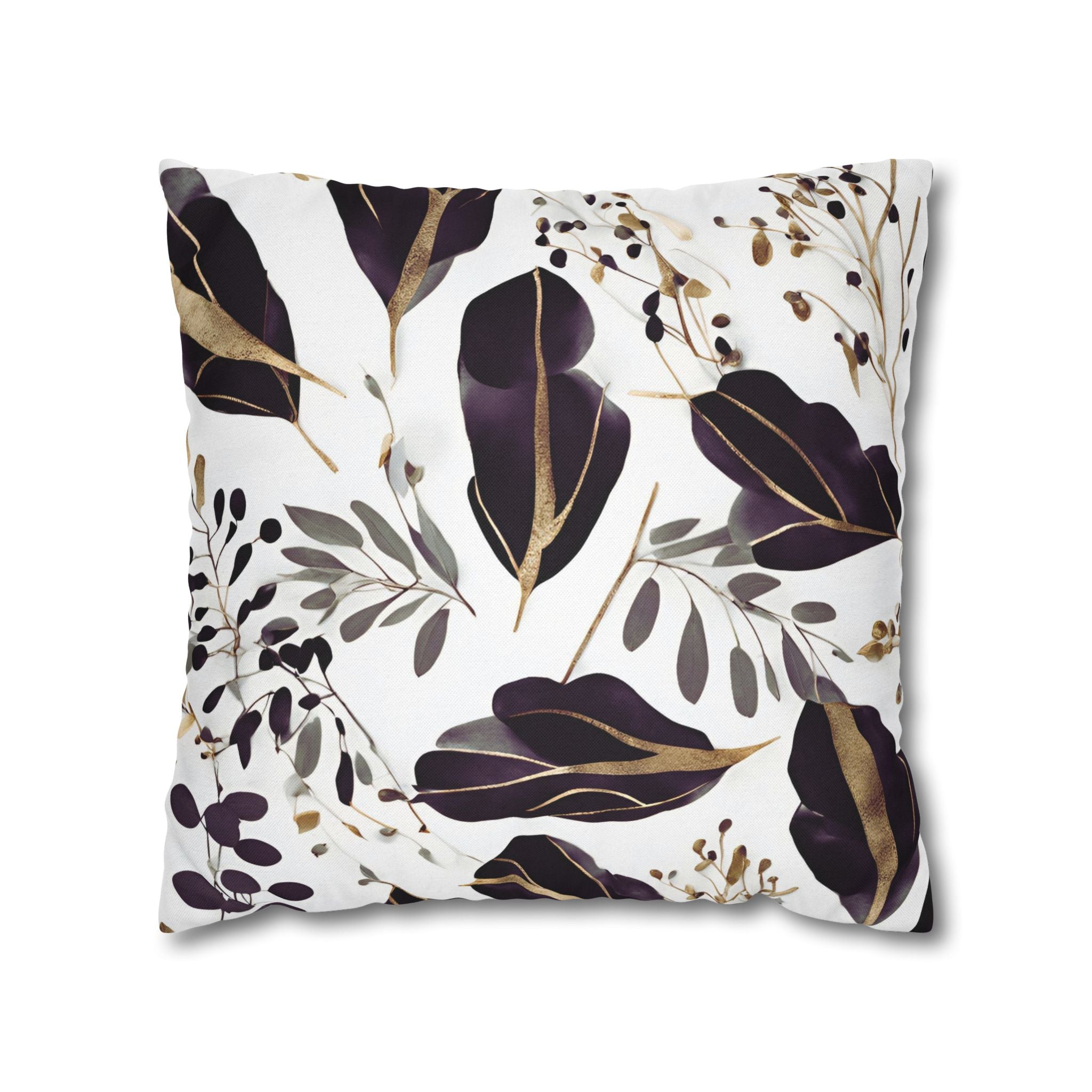 a square pillow with a white background and a repeating pattern of purple leaves and branches with gold accents.