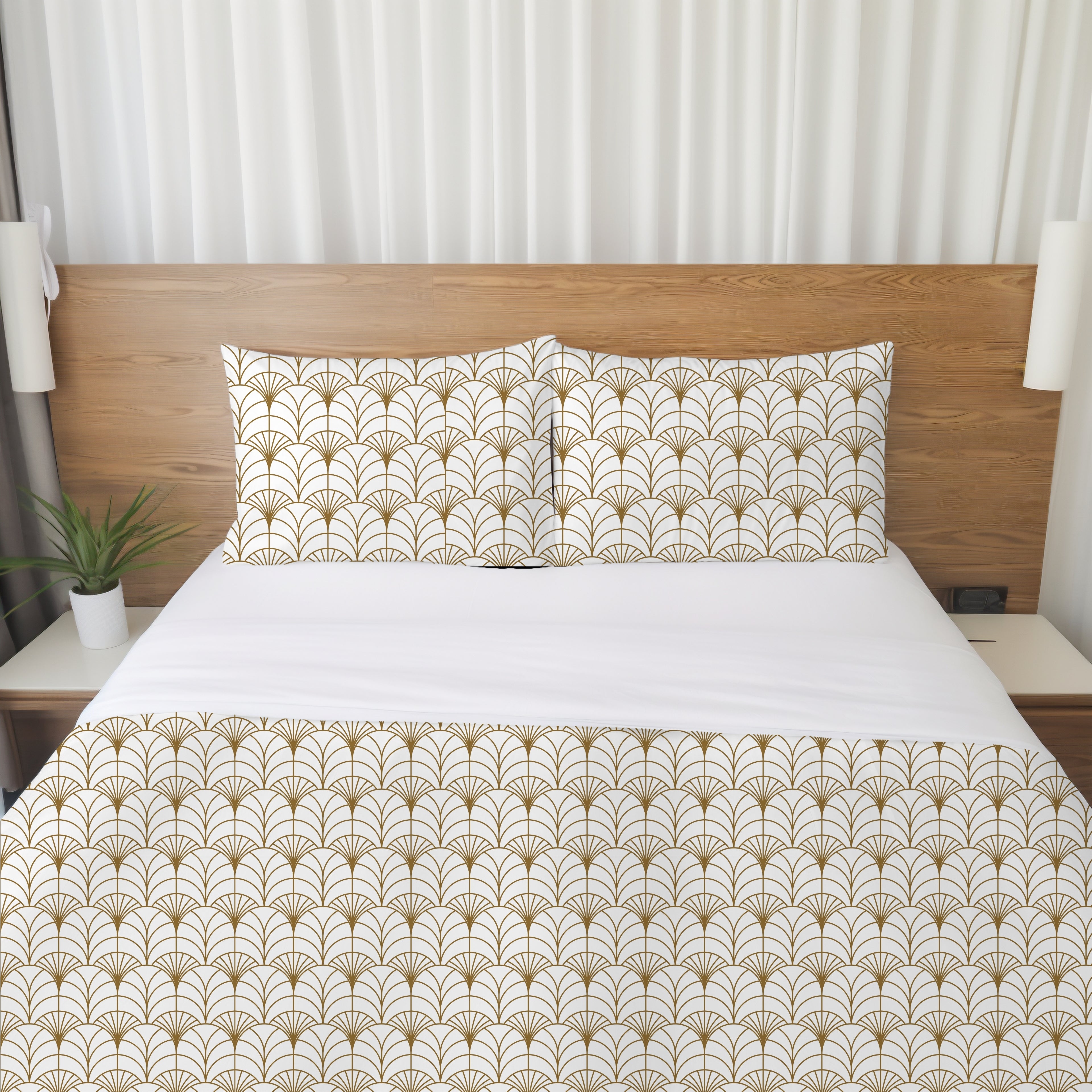 a neatly made bed with a white comforter and pillows featuring a repeating pattern of gold and white designs. The bed is set against a wooden headboard, and there is a potted plant on the left side of the frame.