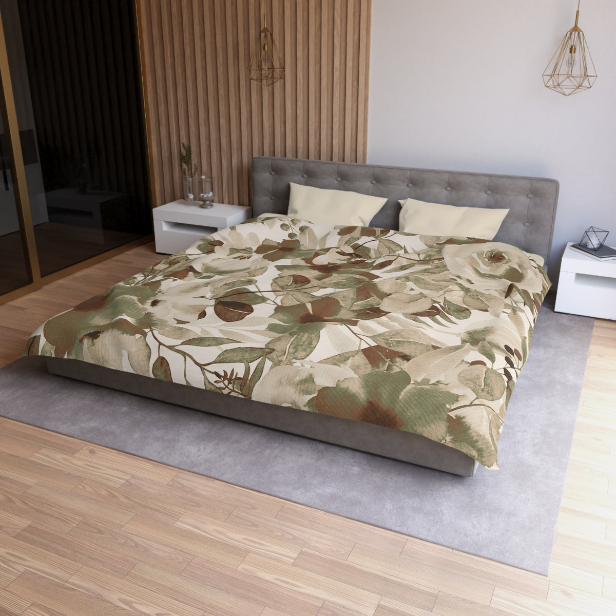 a modern bedroom with a large bed, a gray headboard, and a floral print comforter. The room has a wooden floor and white nightstands on either side of the bed. There is a pendant light hanging above the bed, and a vase on one of the nightstands. The overall design and decor of the room create a serene and inviting atmosphere.
