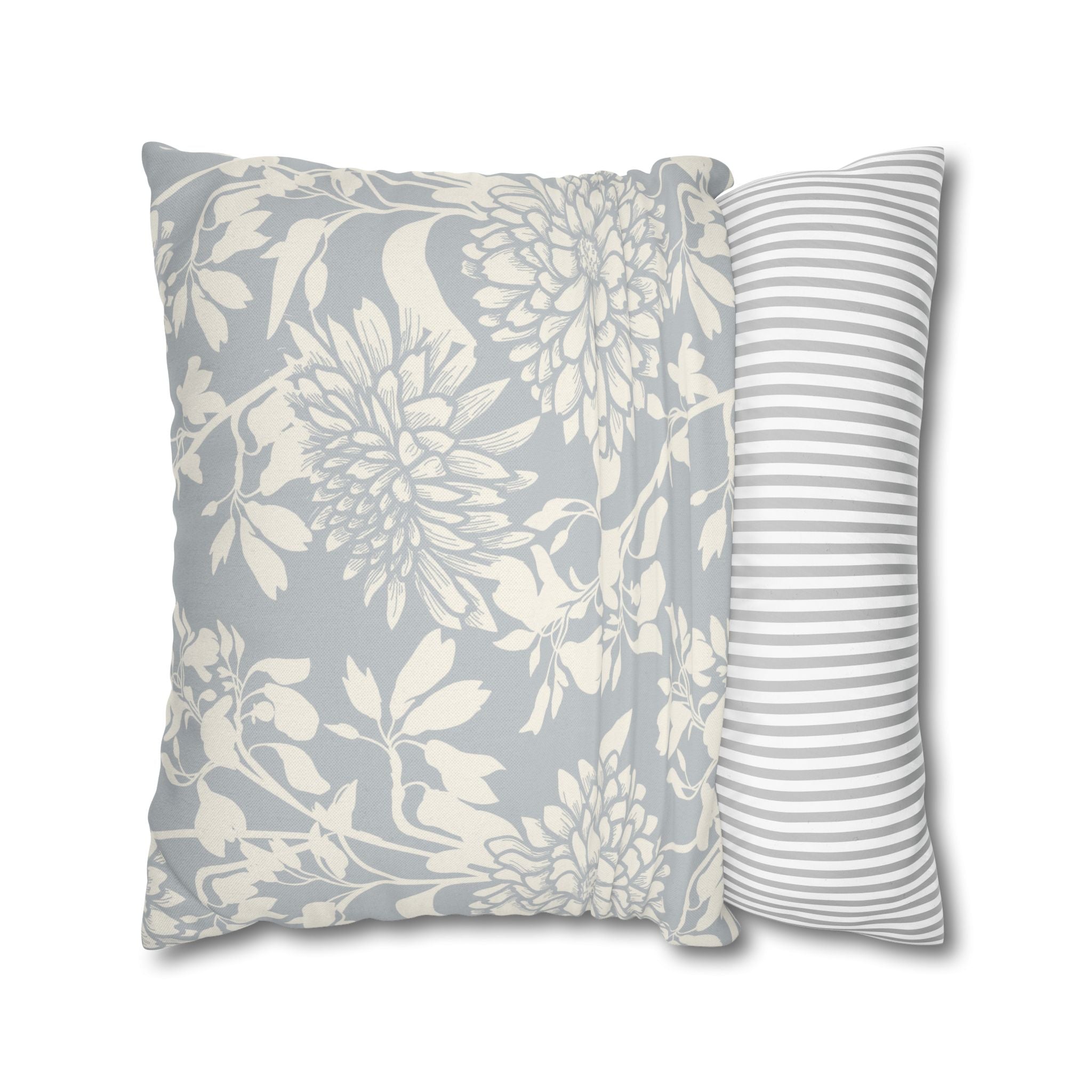 a decorative pillow with a floral pattern in shades of gray and white.