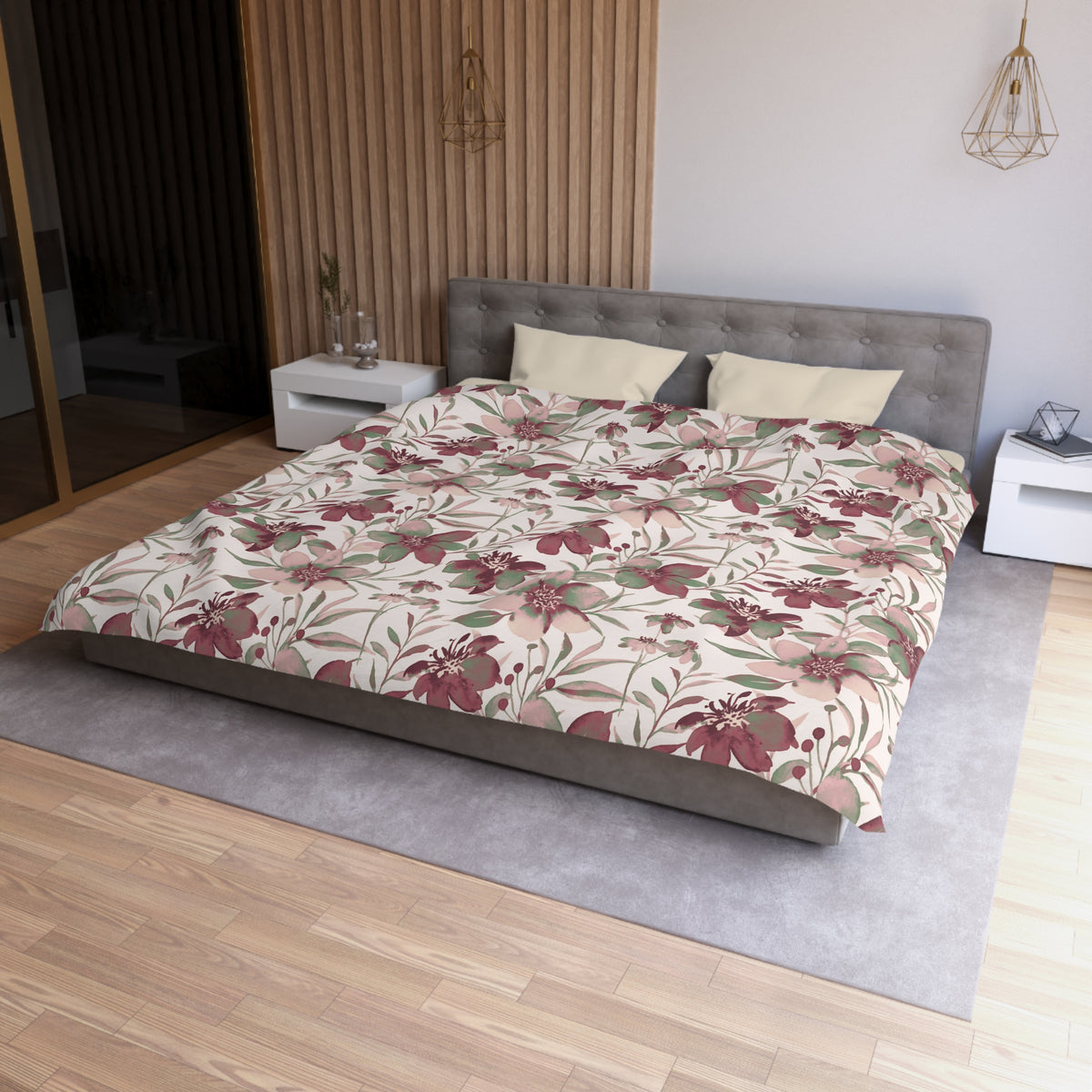 a modern bedroom with a large bed, a gray headboard, and a floral print bedspread. The room has a wooden floor and white walls, creating a clean and minimalist aesthetic.