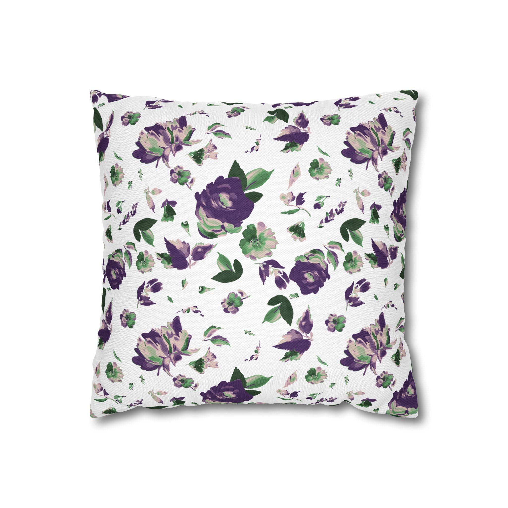 a square throw pillow with a floral pattern in shades of purple and green.