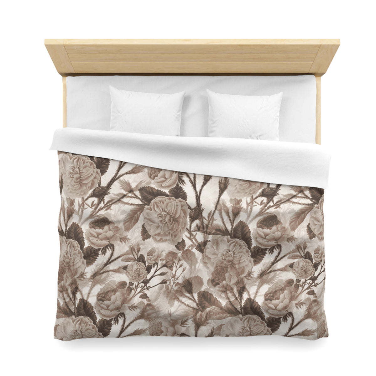 a neatly made bed with a floral print comforter and two white pillows.