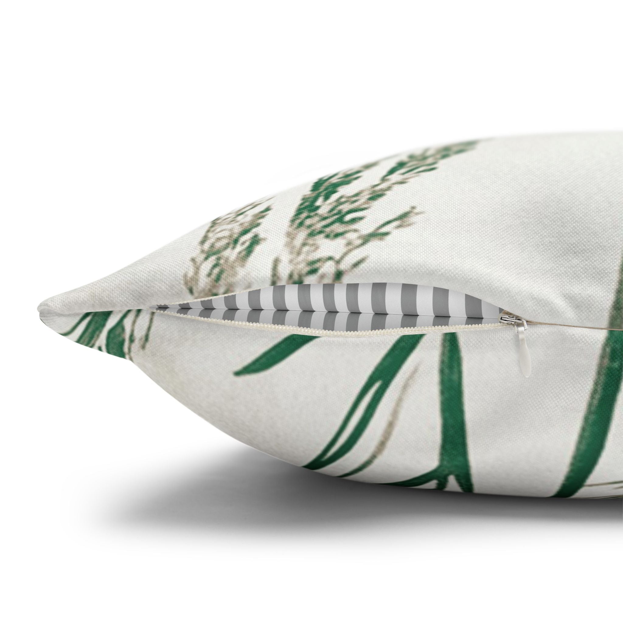 a close-up view of a white pillow with a green leaf pattern.