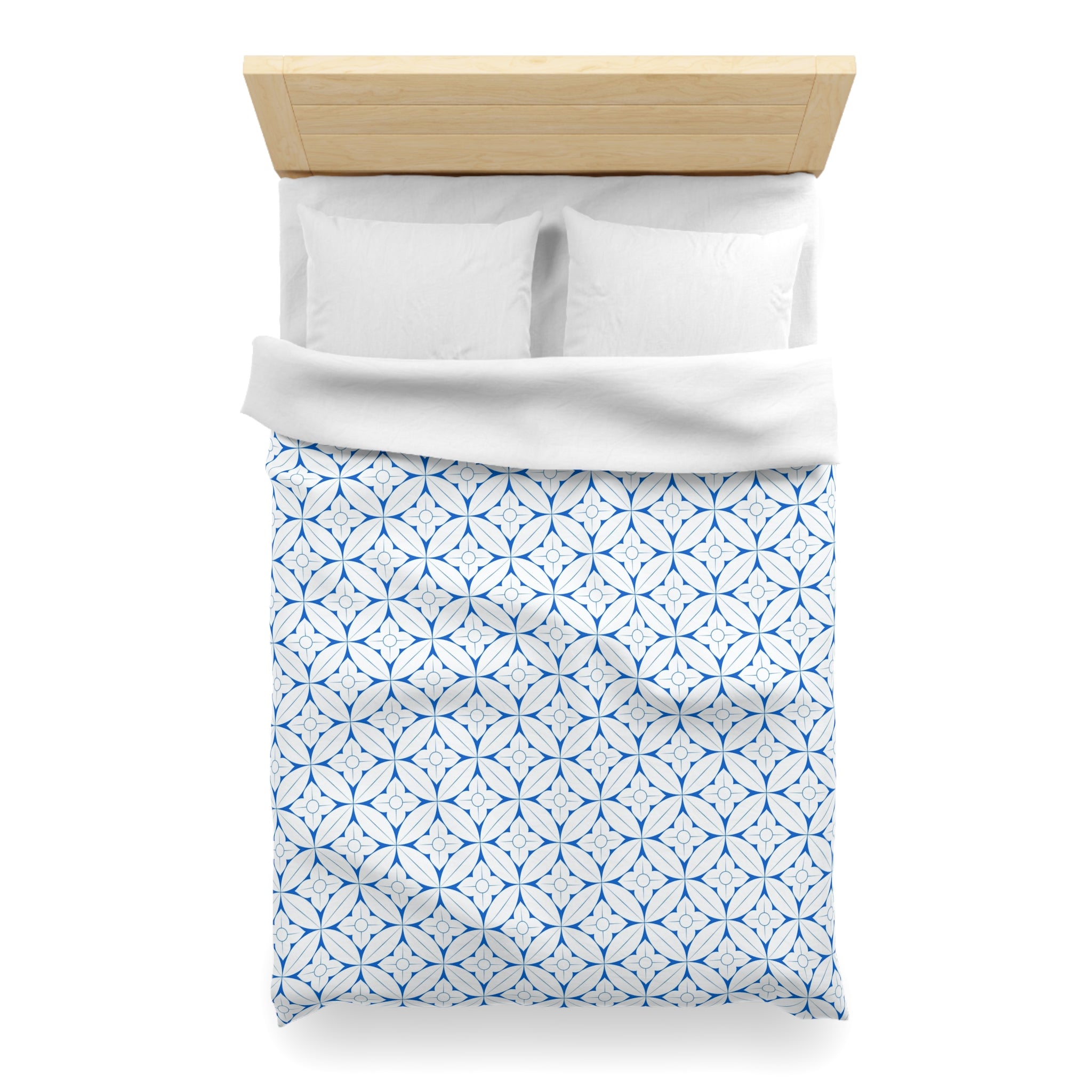 a neatly made bed with a white comforter and a blue patterned duvet cover.