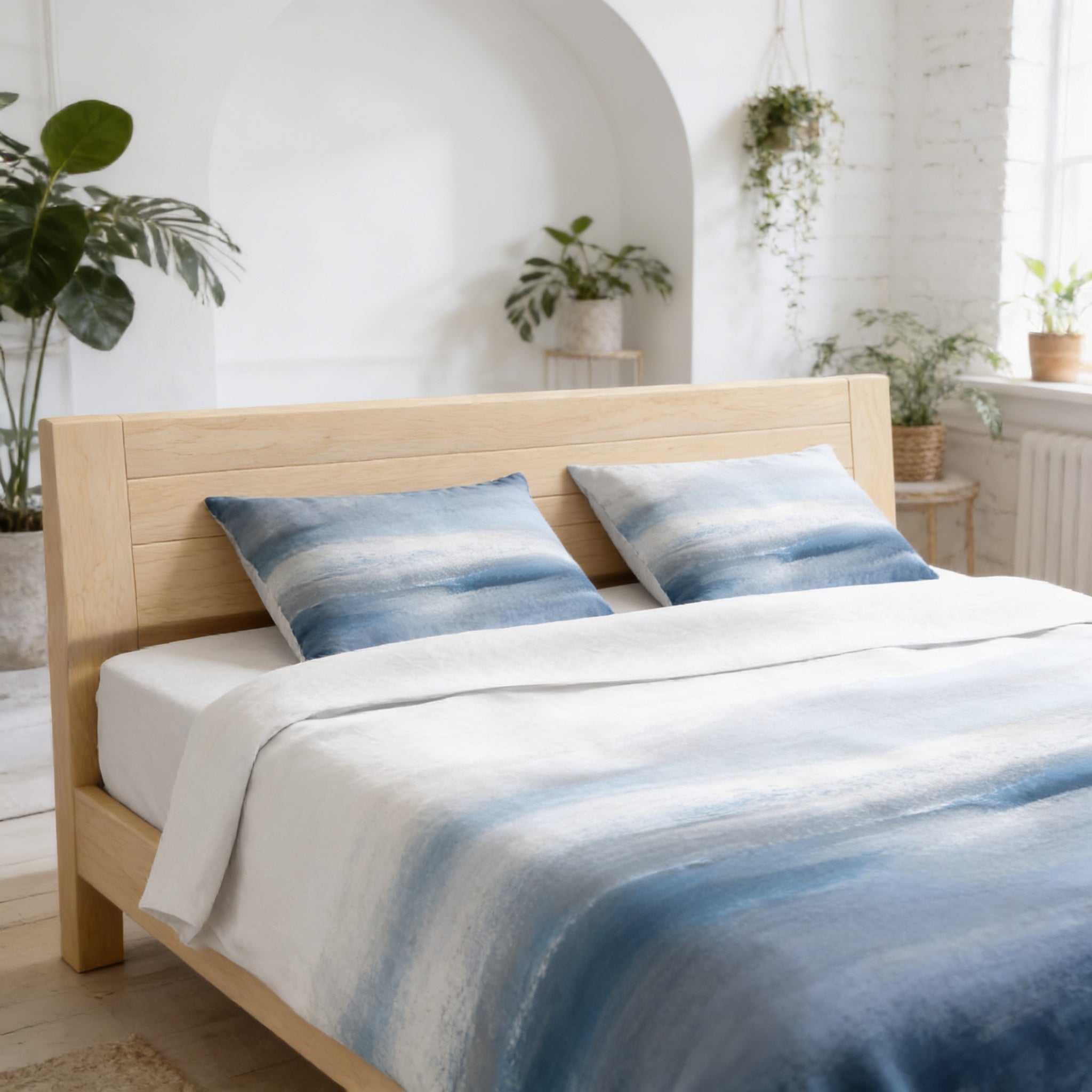 a cozy bedroom with a wooden bed frame, a white and blue patterned comforter, and two blue and white patterned pillows. The room is decorated with potted plants and a white archway, creating a serene and inviting atmosphere.