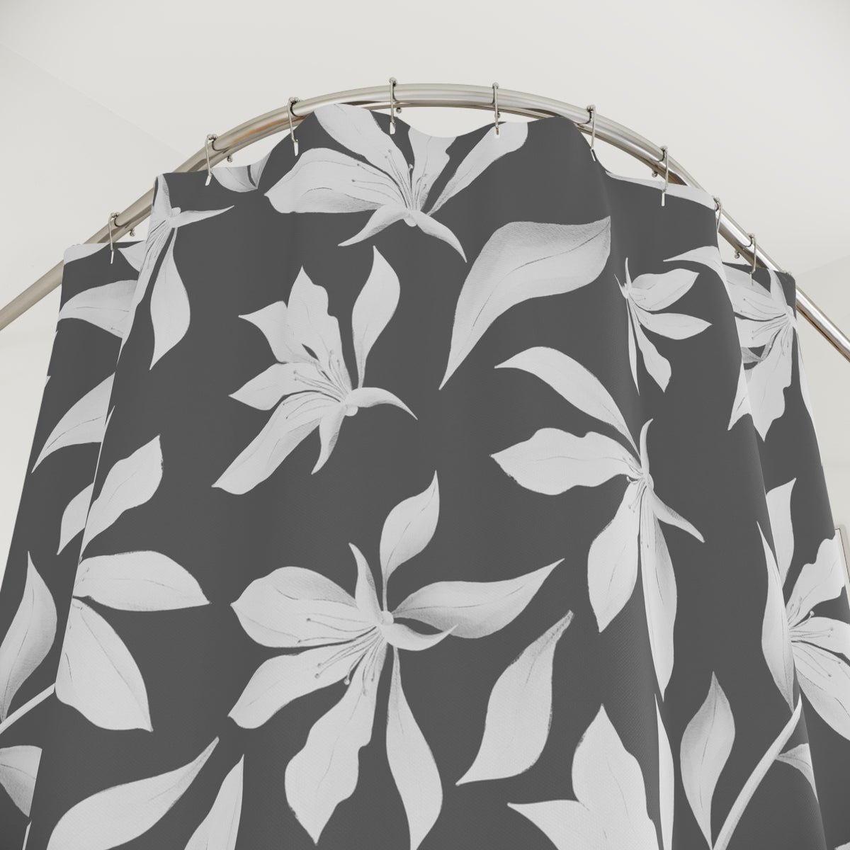 a black and white patterned shower curtain hanging from a rod.