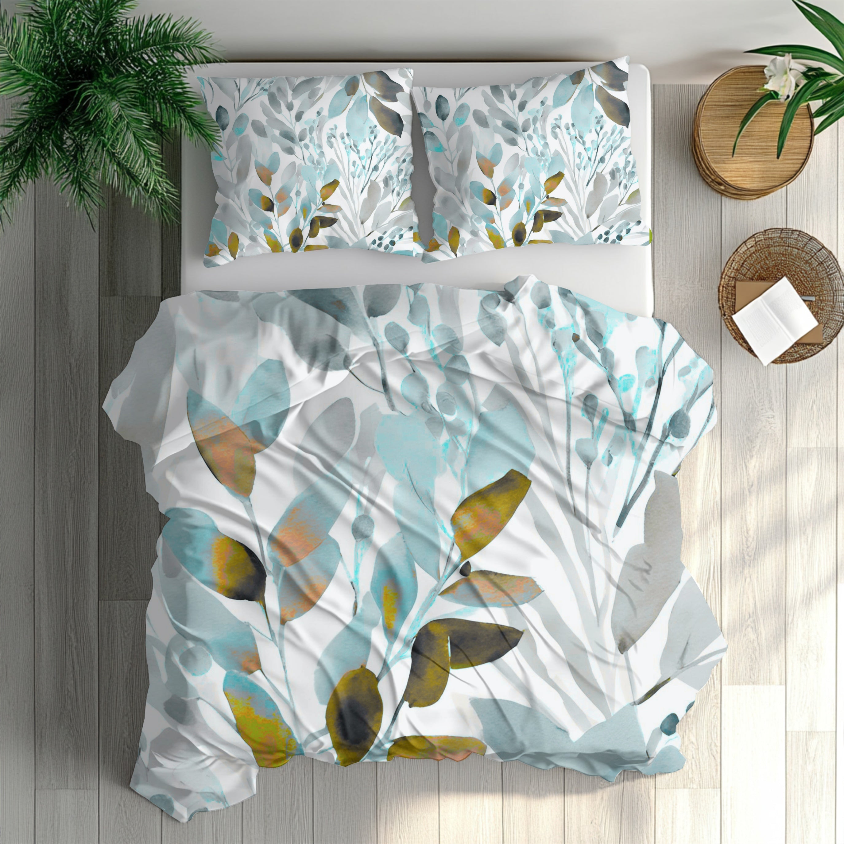 a bedroom with a bed covered in a white comforter featuring a leafy, abstract pattern in shades of blue, green, and orange. The bed is set against a backdrop of a wooden floor and a wall, with a potted plant and a basket nearby.