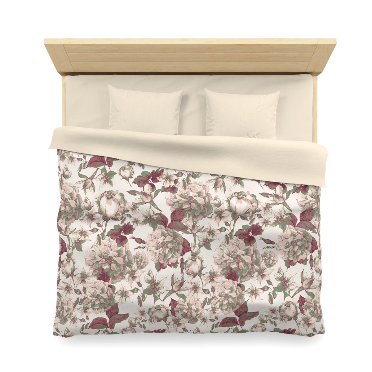 a neatly made bed with a floral print comforter and pillows.