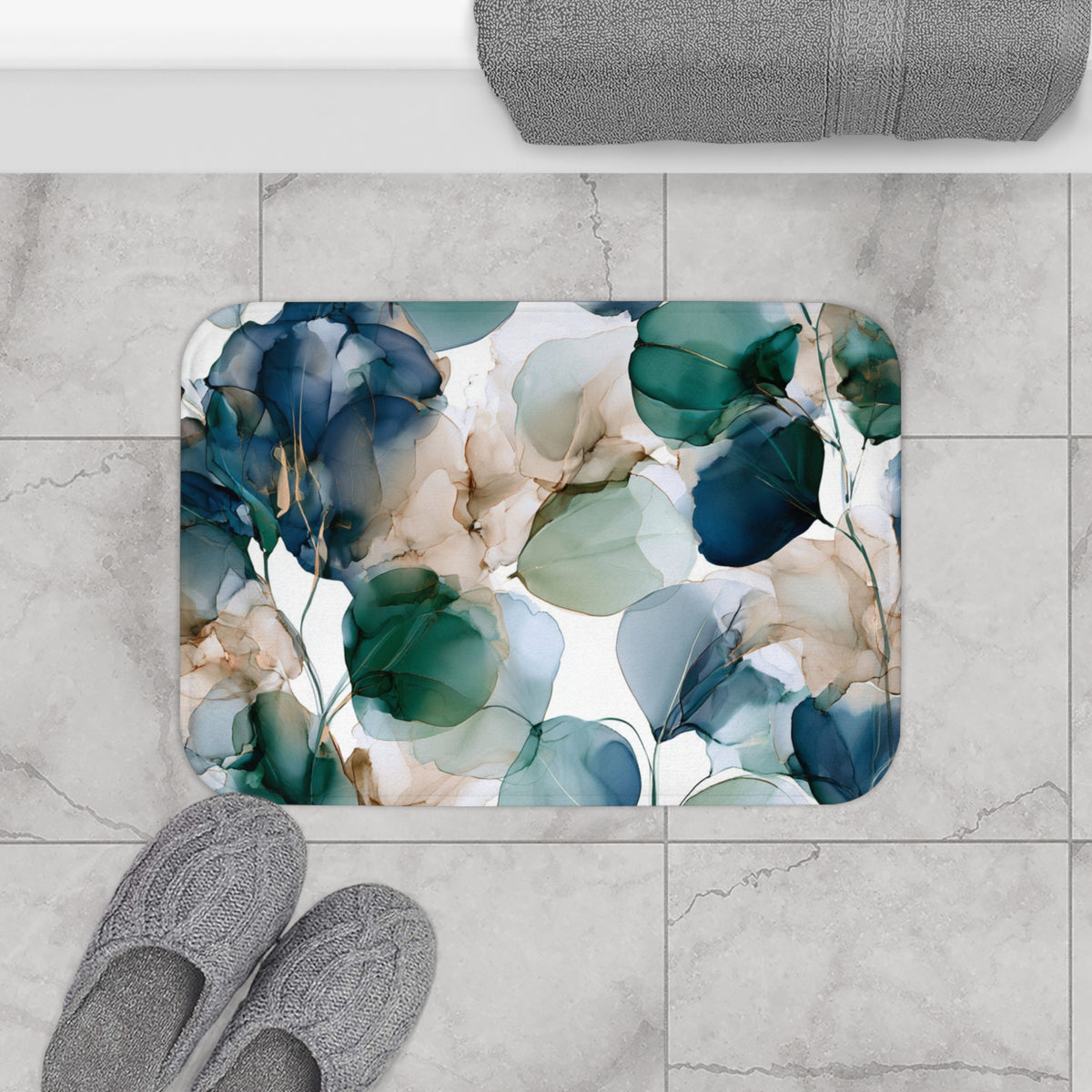 a pair of gray slippers sitting on top of a bathroom floor