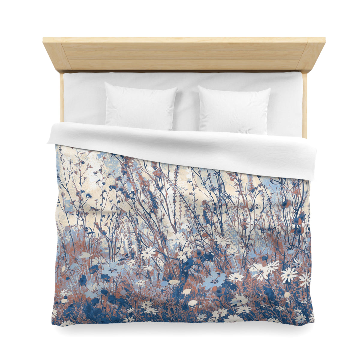 a bed with a floral patterned comforter and pillows.
