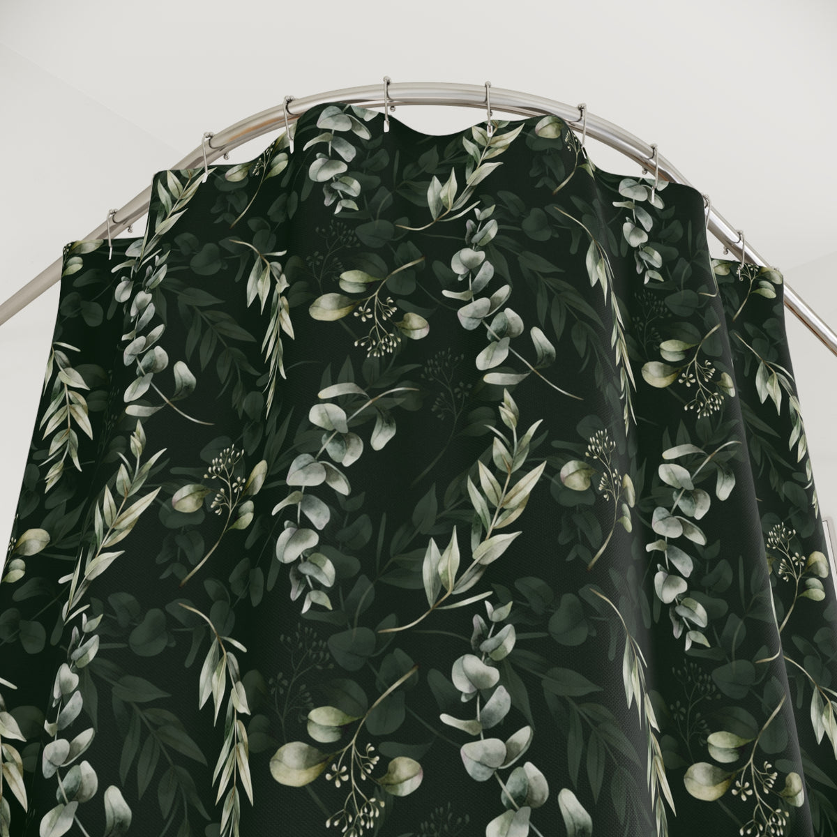 a black shower curtain with a repeating pattern of green leaves and flowers.