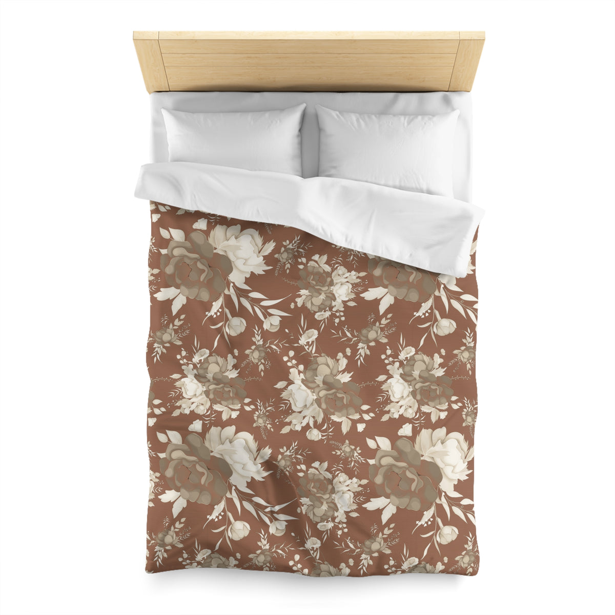 a bed with a floral print comforter and pillows.