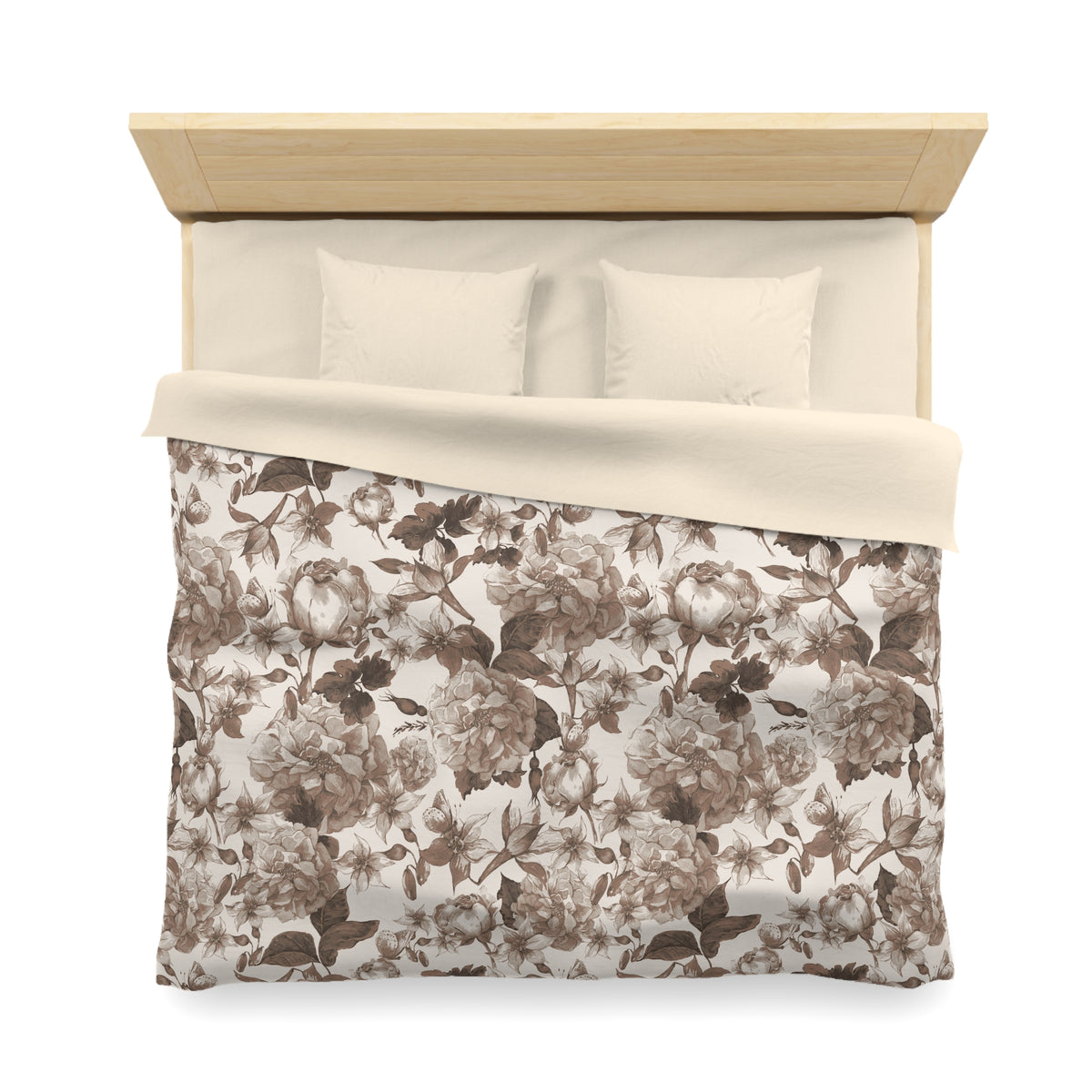 a neatly made bed with a floral patterned comforter and two pillows.
