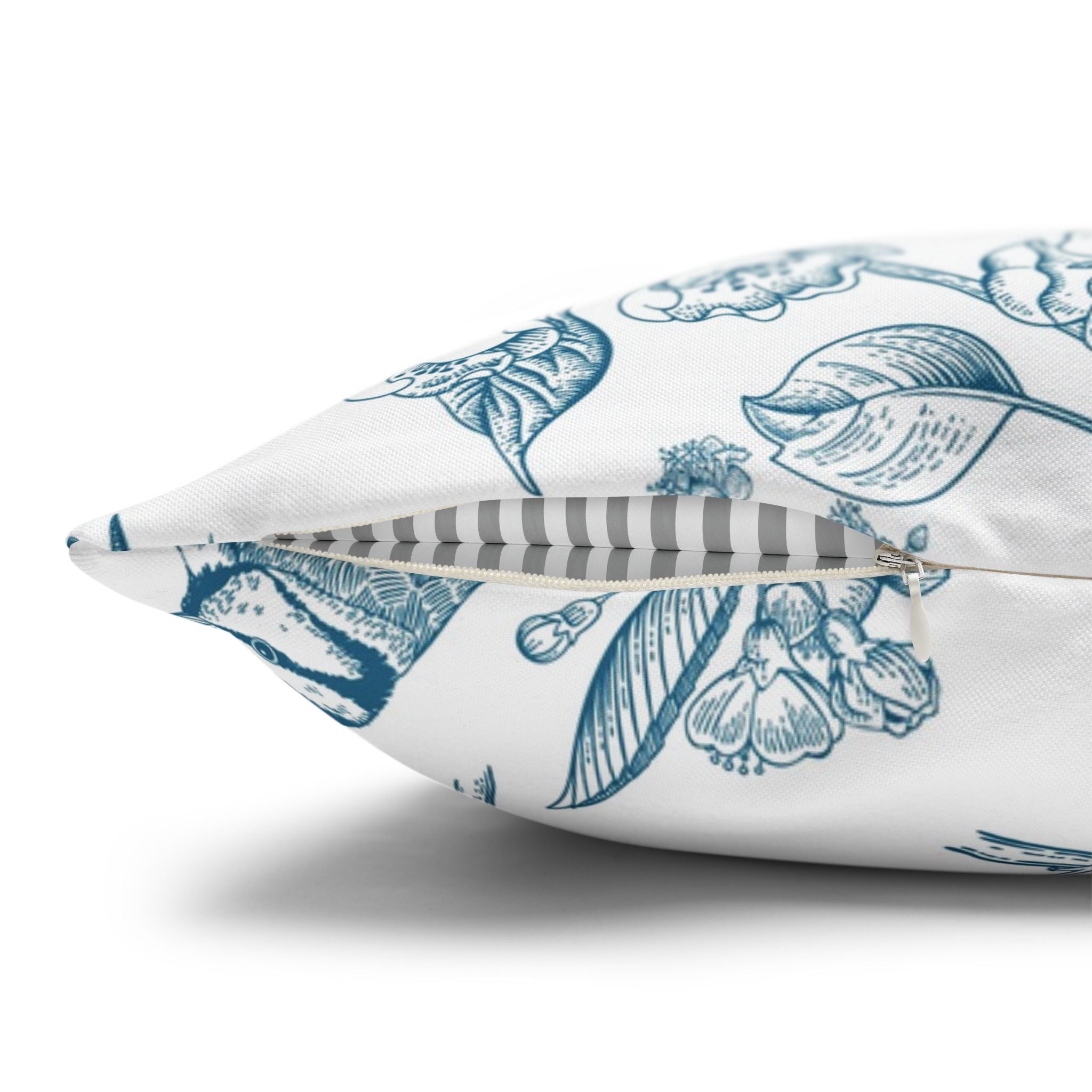 a close-up view of a white pillow with a blue floral pattern.