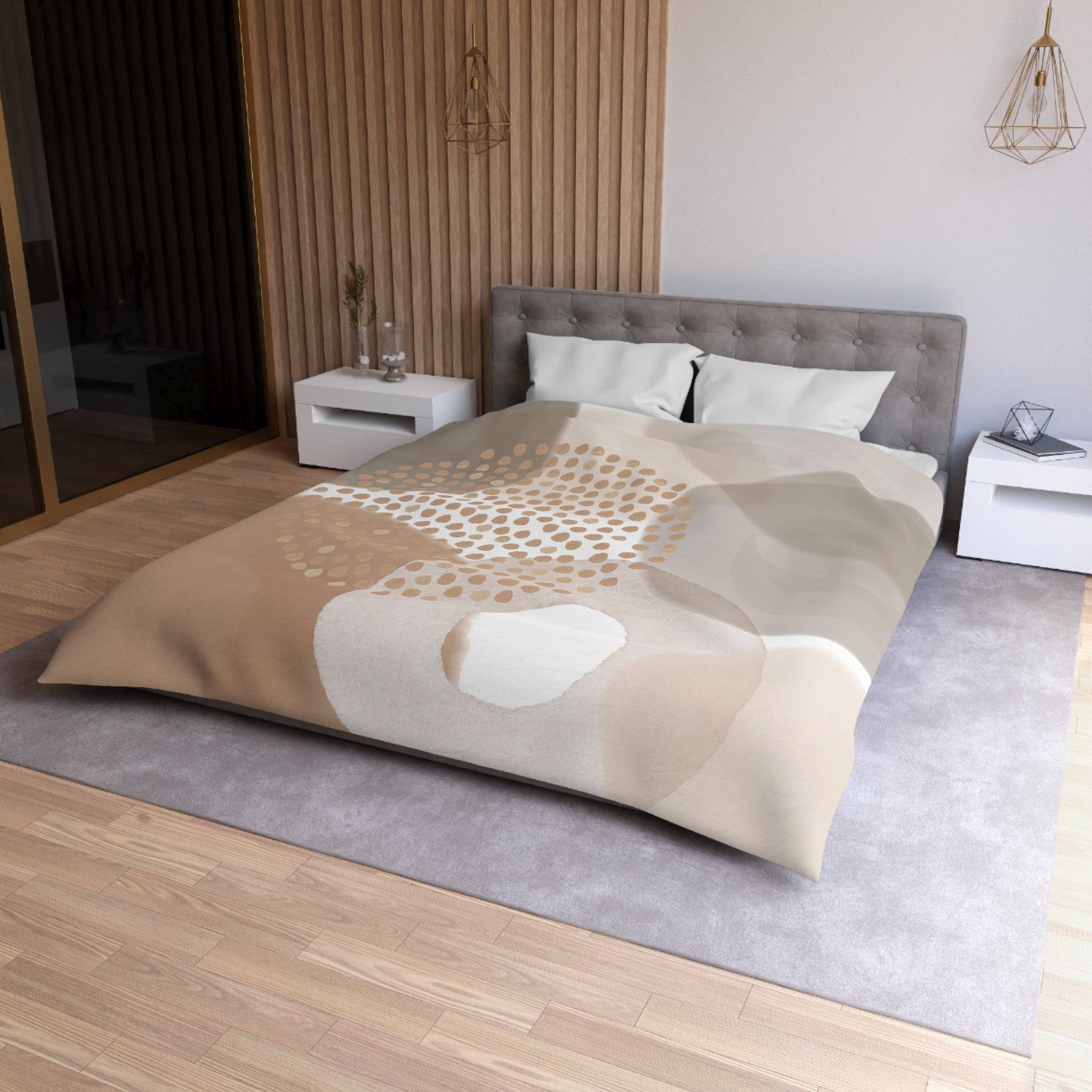a modern bedroom with a large bed, a gray headboard, and a neutral-colored bedspread featuring a pattern of circles and dots. The room has a wooden floor and white nightstands on either side of the bed.