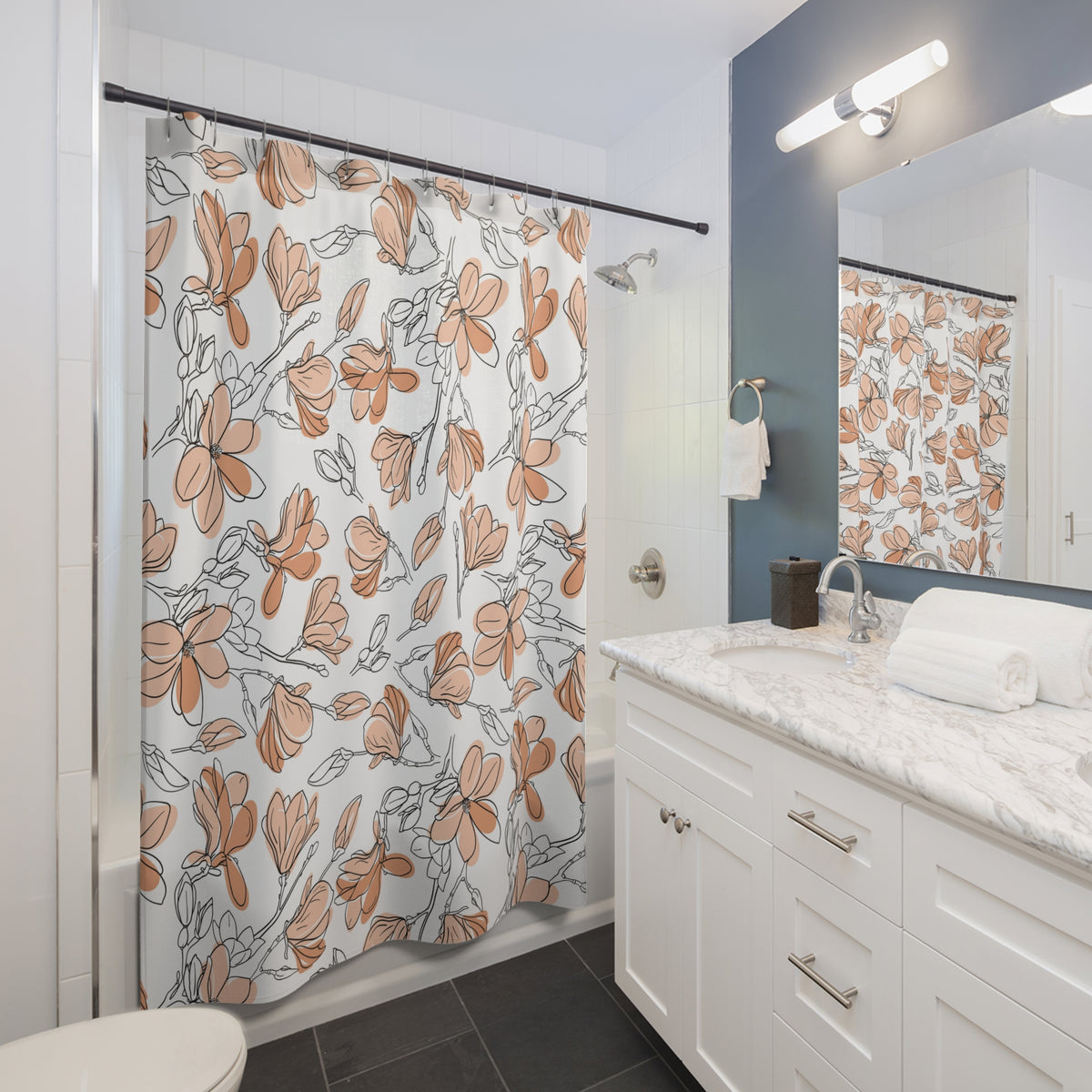 a modern bathroom with a white vanity, a shower curtain with a floral pattern, and a mirror above the vanity.