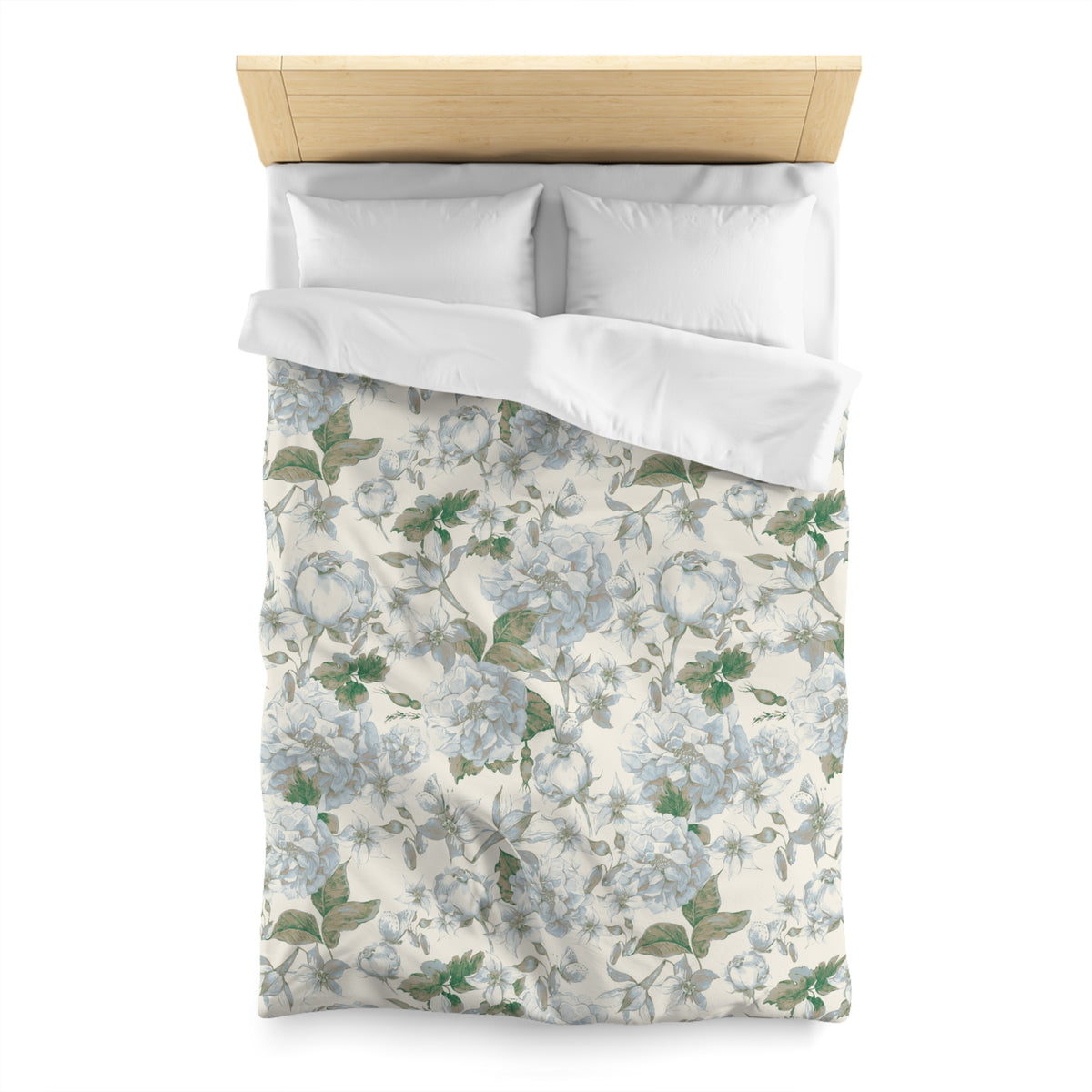 a neatly made bed with a floral print duvet cover and two white pillows.