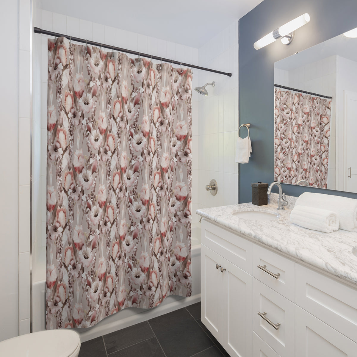 a modern bathroom with a white vanity, a shower curtain with a floral pattern, and a mirror above the vanity.
