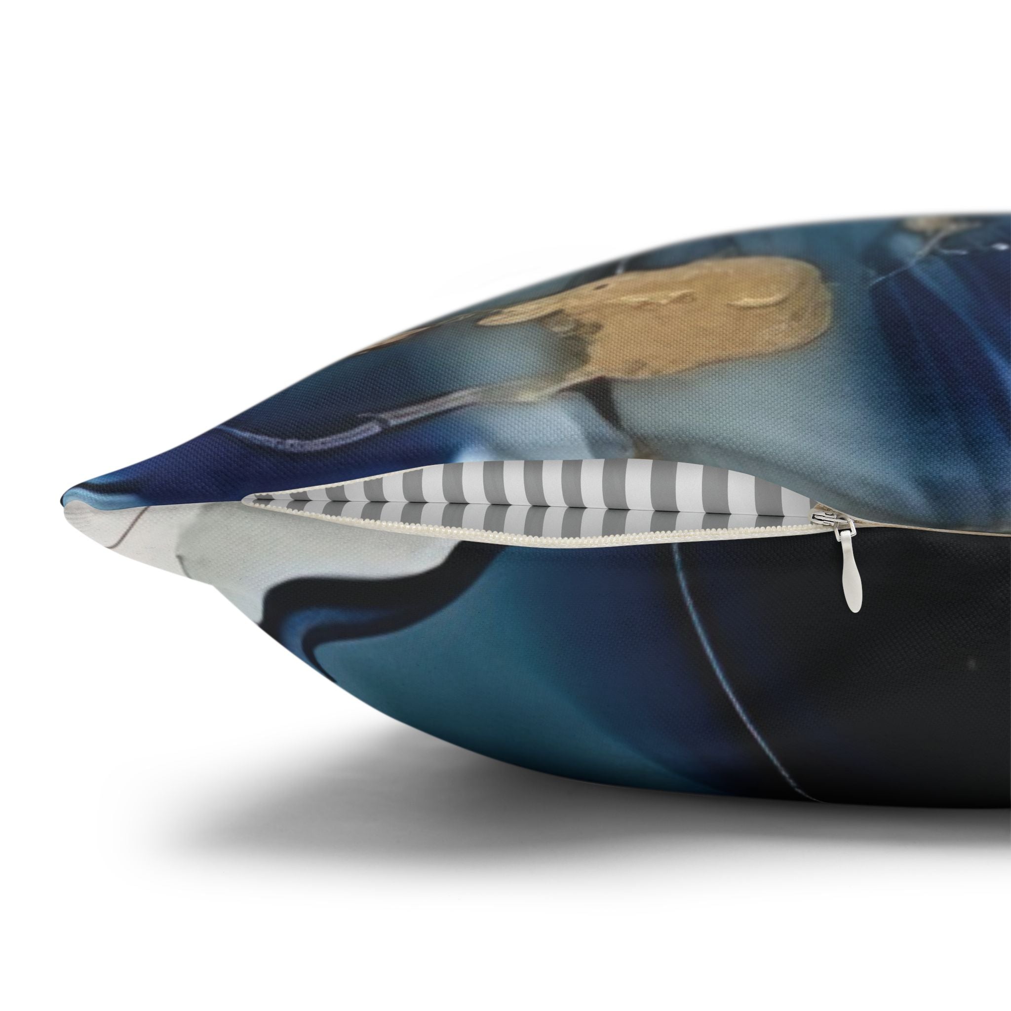 a close-up view of a pillow with a metallic blue and black pattern, featuring a zipper running along the edge.
