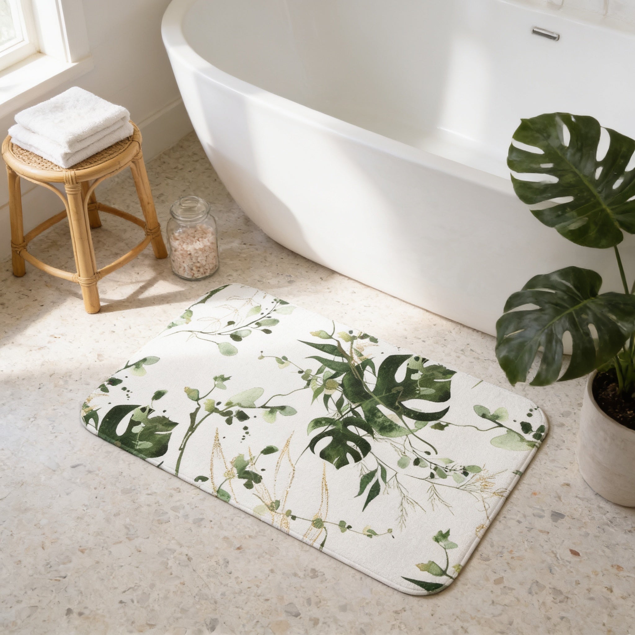 a bathroom with a white bathtub, a rug with a green leaf pattern, a small potted plant, and a wooden stool.