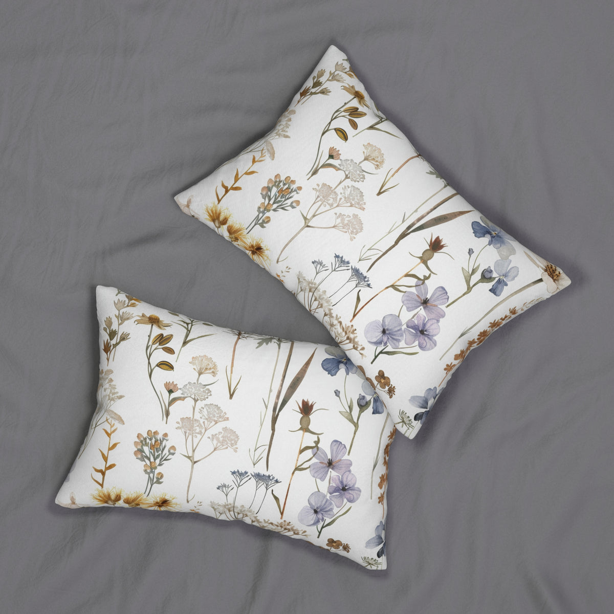 two white pillows with a floral print pattern, placed on a gray surface.