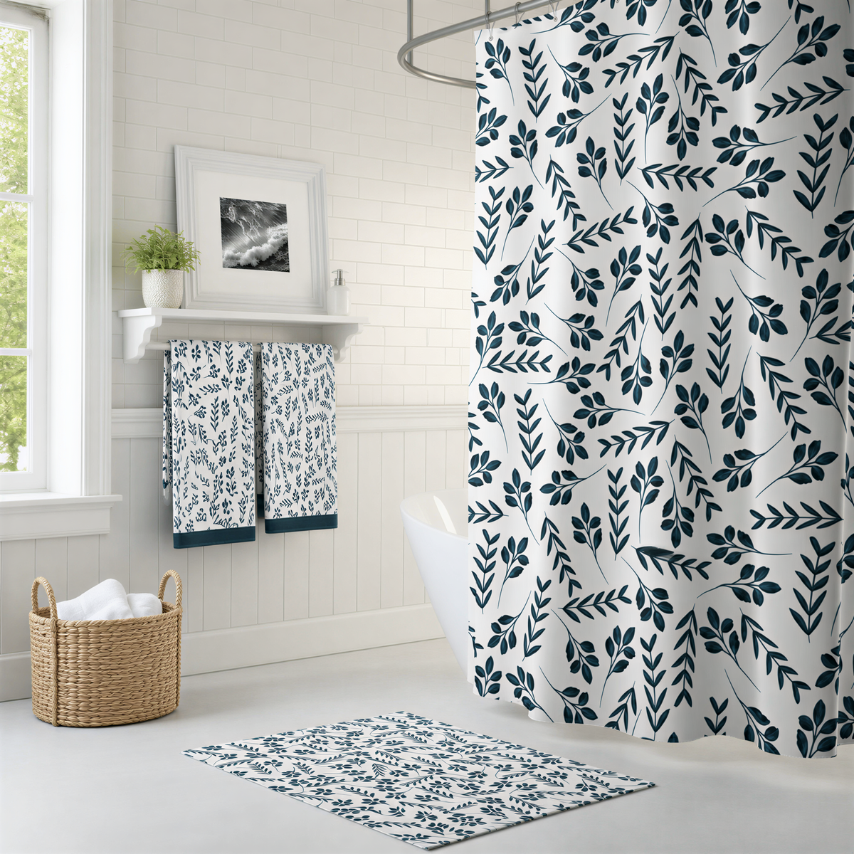 a bathroom with a shower curtain featuring a leafy pattern in shades of blue and white. The bathroom has white walls, a white tile floor, and a white shelf with towels and a plant. There is a basket on the floor and a rug on the floor.