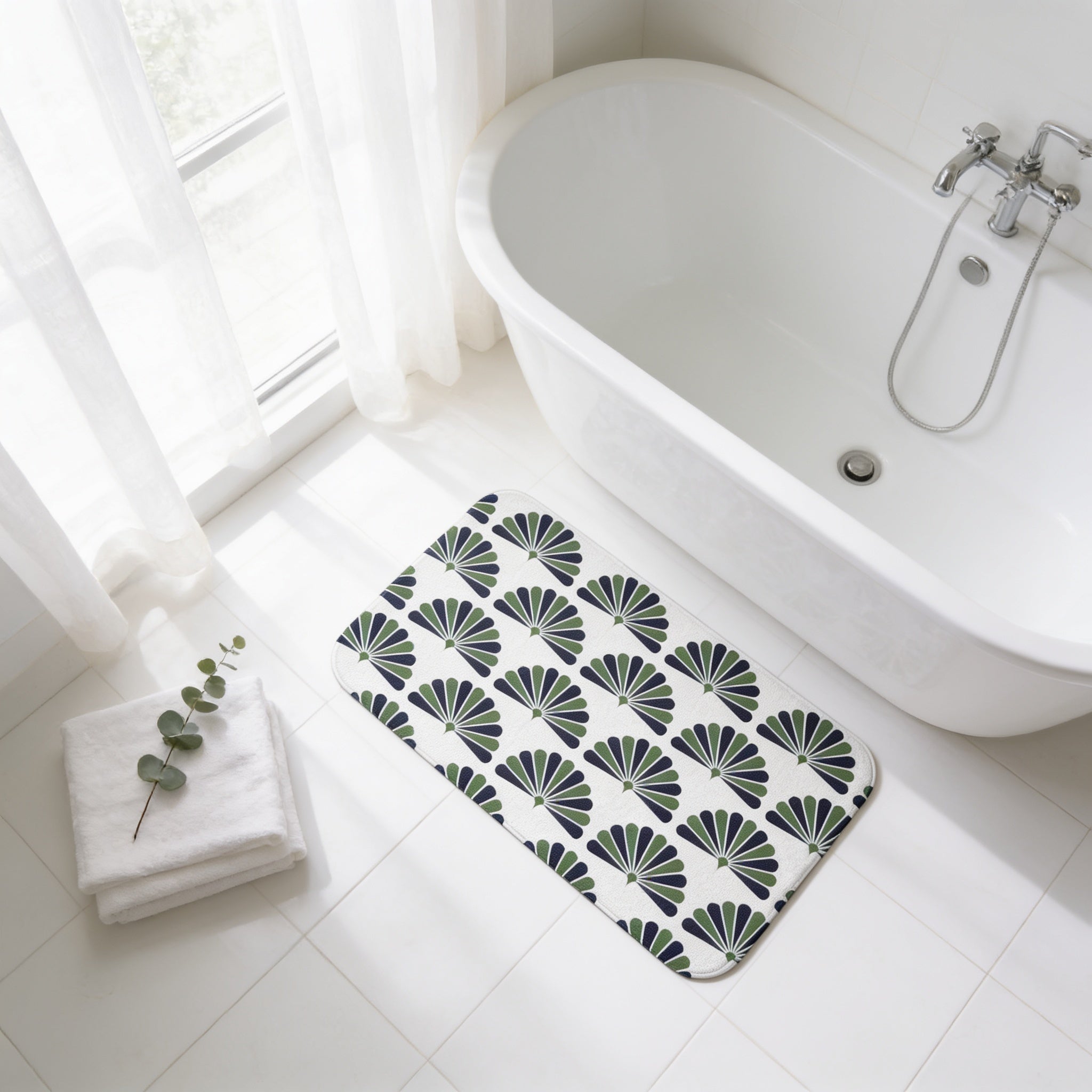 a bathroom with a white bathtub, a towel, and a decorative bath mat with a fan-shaped pattern.