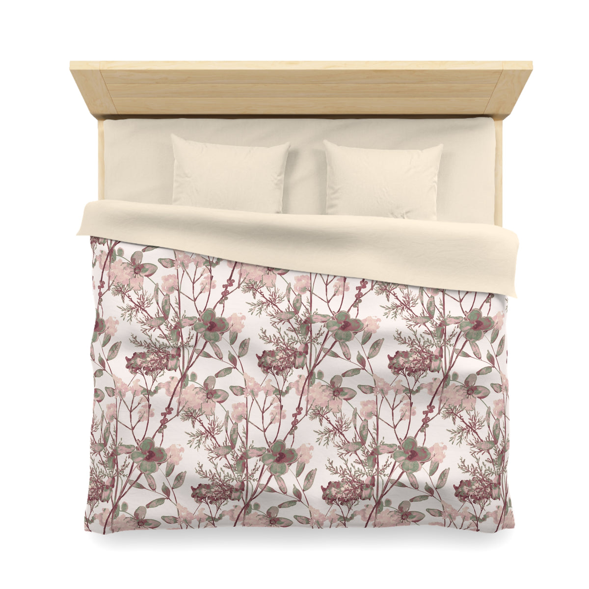 a neatly made bed with a floral print comforter and pillows.