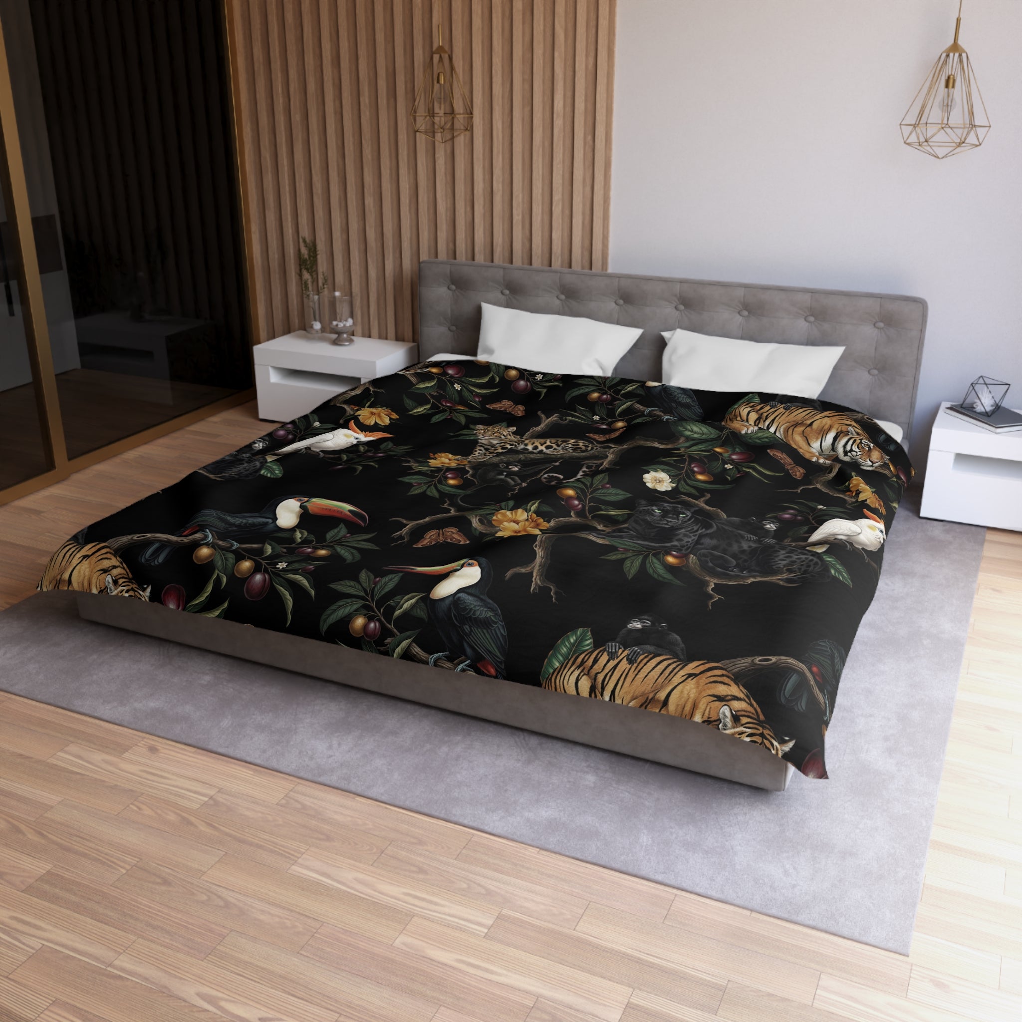 a bedroom with a large bed covered in a black and gold patterned comforter. The bed is positioned against a wall with a wooden panel. There are two nightstands on either side of the bed, and a pendant light hangs above the bed. The room has a modern and stylish design, with a focus on the bed as the central element.