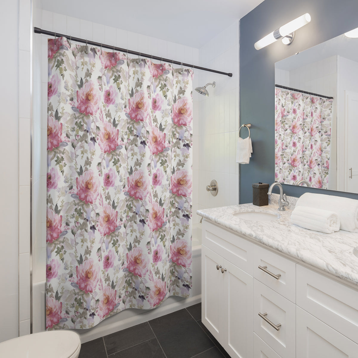 a well-lit bathroom with a white vanity, a floral shower curtain, and a mirror above the sink.
