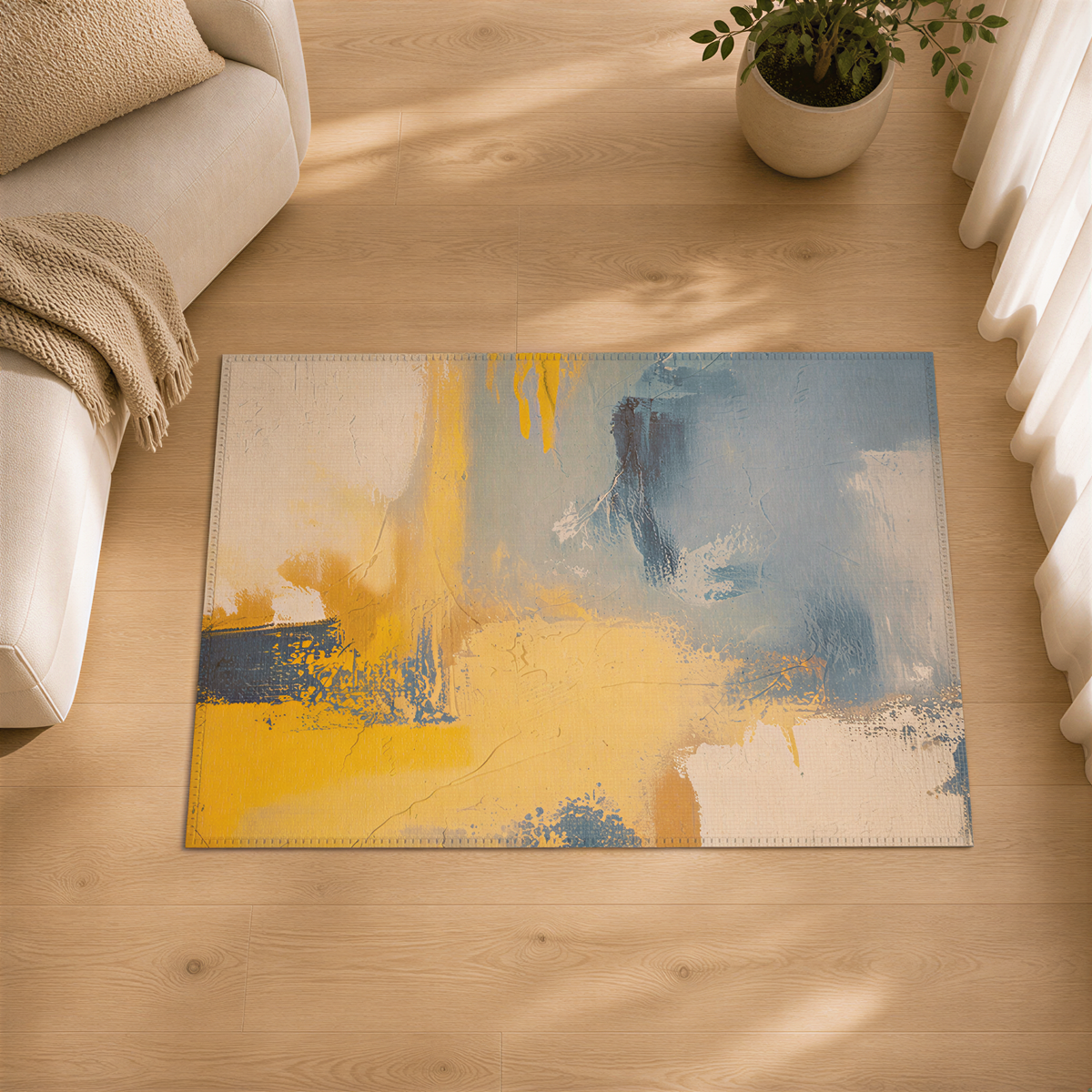 a large abstract painting with a mix of blue, yellow, and white colors, displayed on a wooden floor in a living room setting.