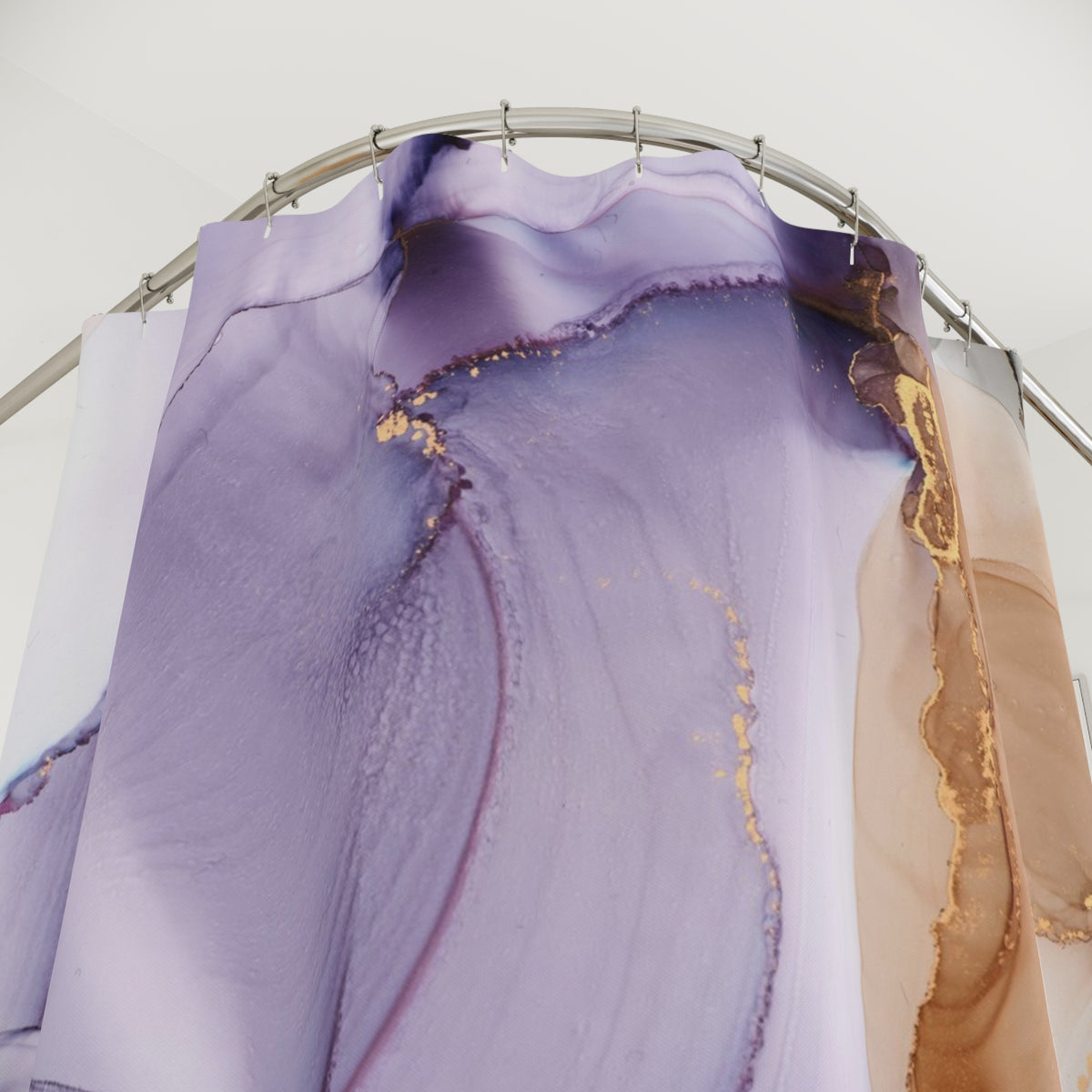 a shower curtain with a purple and brown abstract design, hanging from a metal rod.