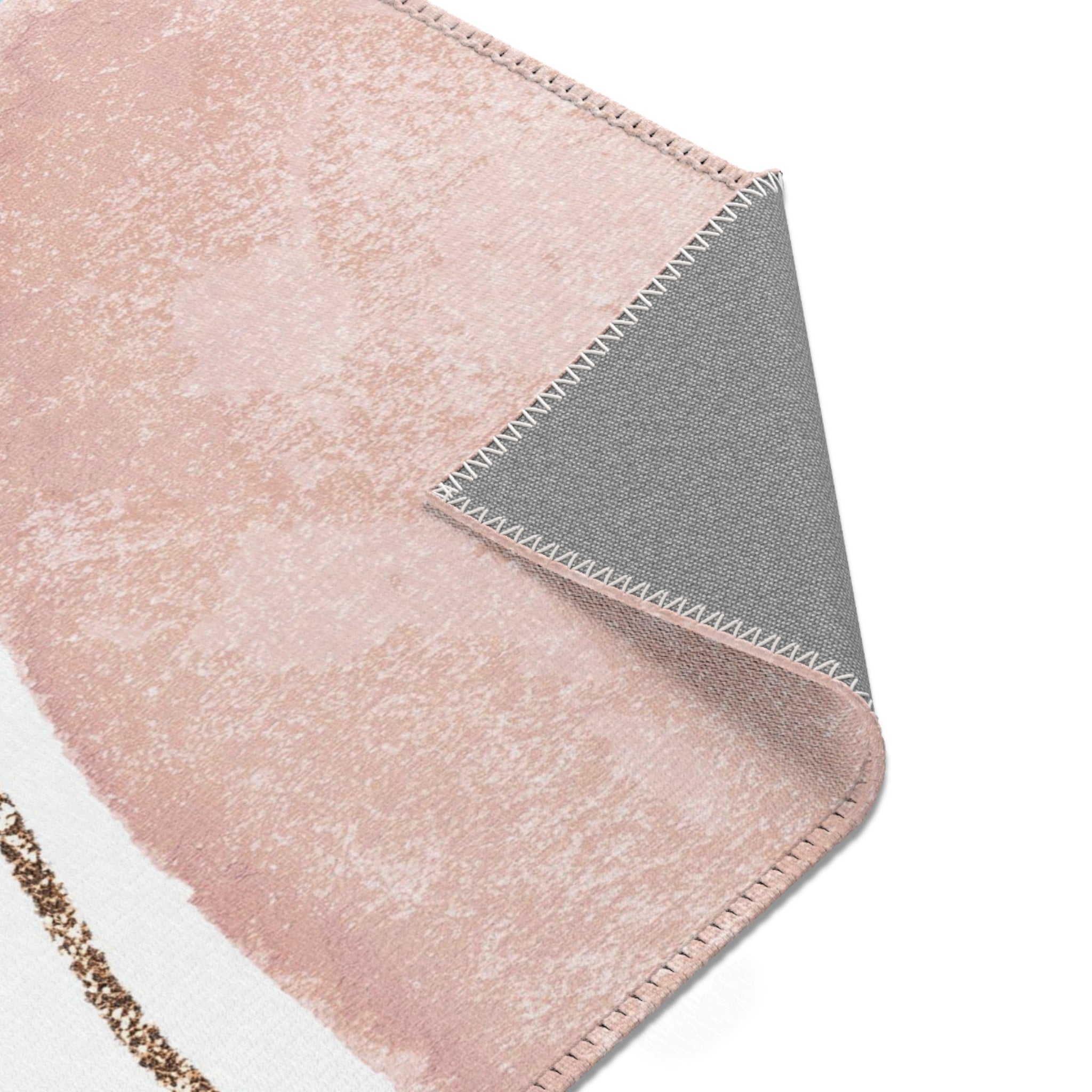 Modern blush pink and sky blue abstract boho rectangle area rug shown under furniture in a styled room