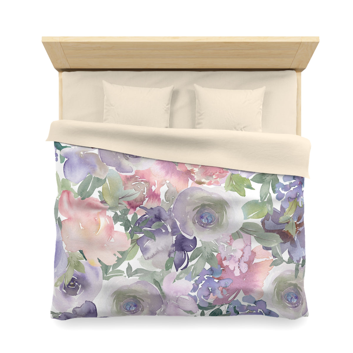 a bed with a floral print duvet cover and pillows.