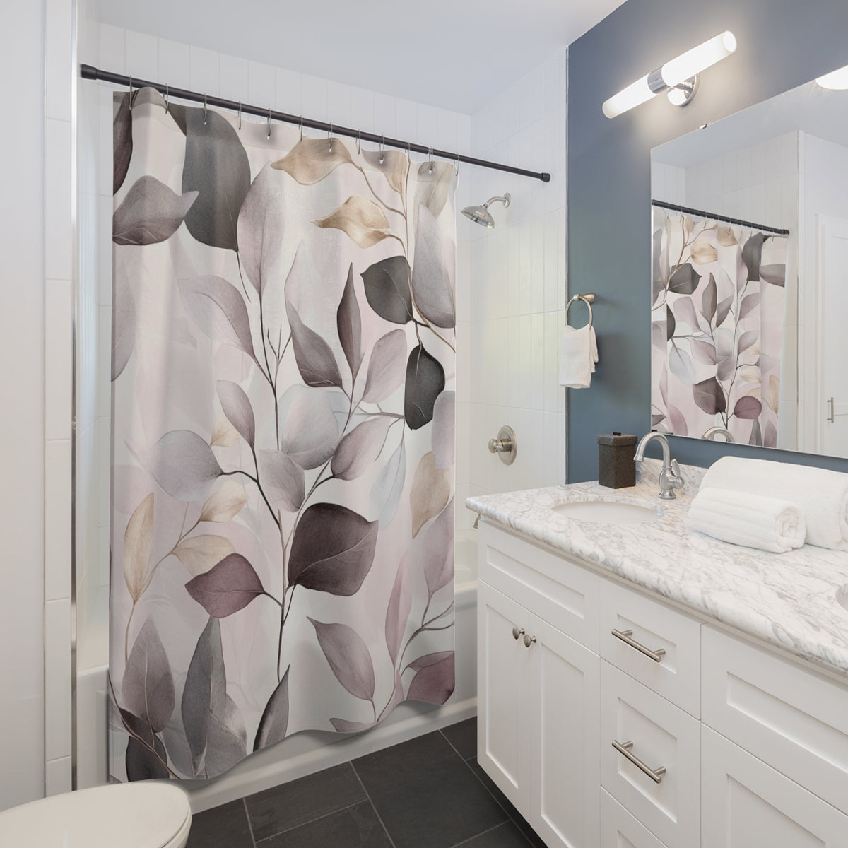 a modern bathroom with a white vanity, a shower curtain with a leaf pattern, and a mirror above the vanity.