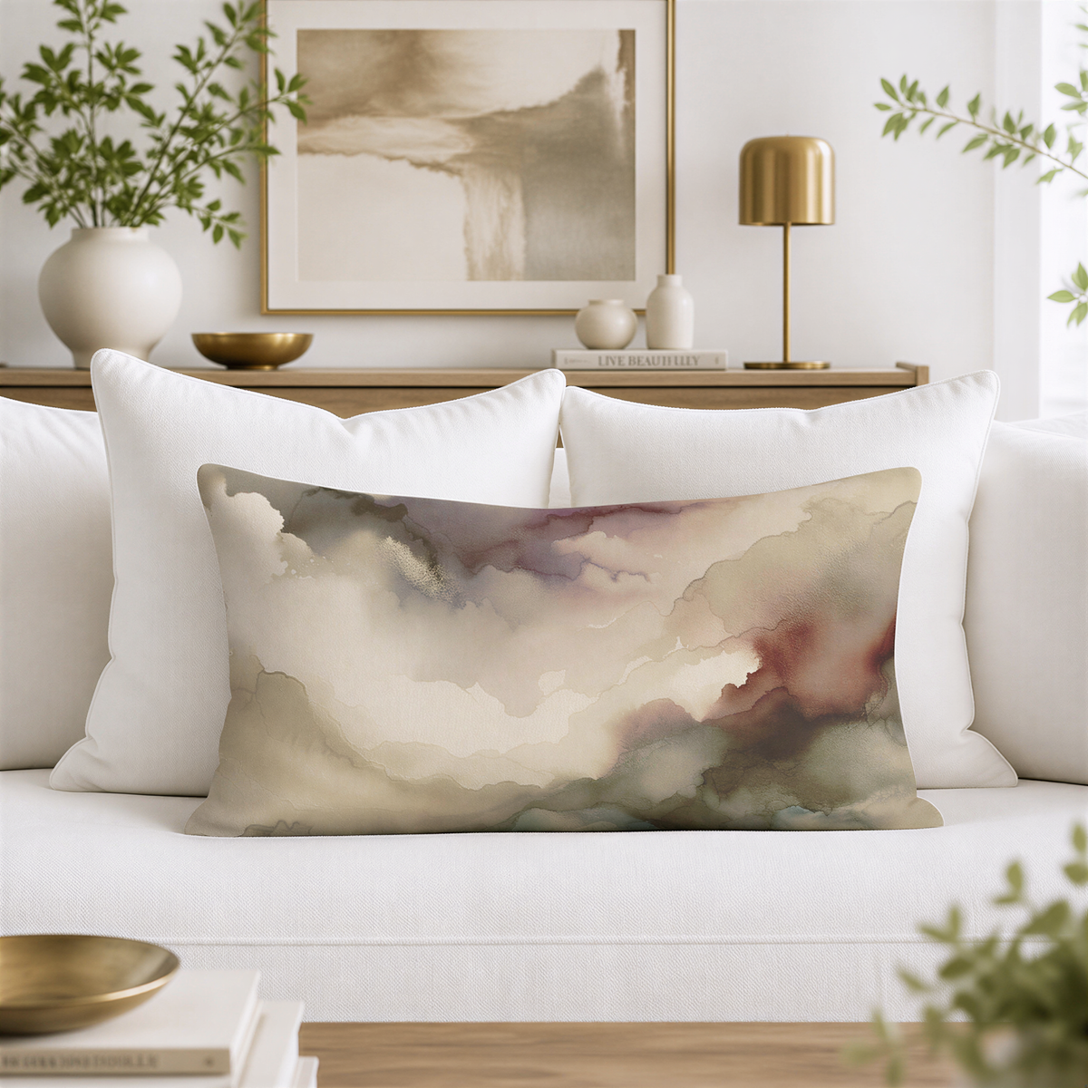a living room with a white sofa, a decorative pillow with a cloud-like design, and a framed artwork on the wall.