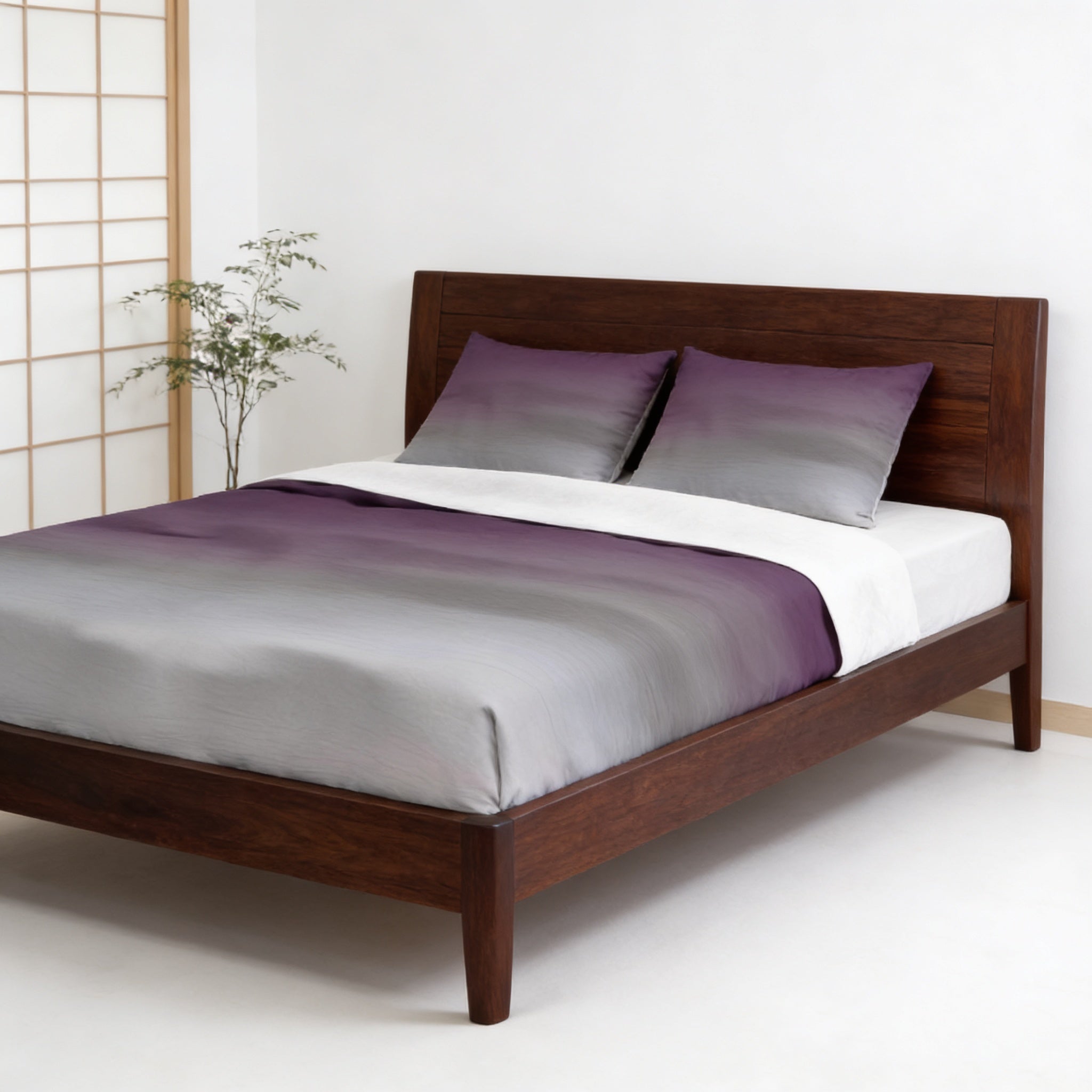a modern bedroom with a wooden bed frame and a gray and purple striped comforter. The bed is positioned against a white wall, and there is a small plant on the left side of the frame.