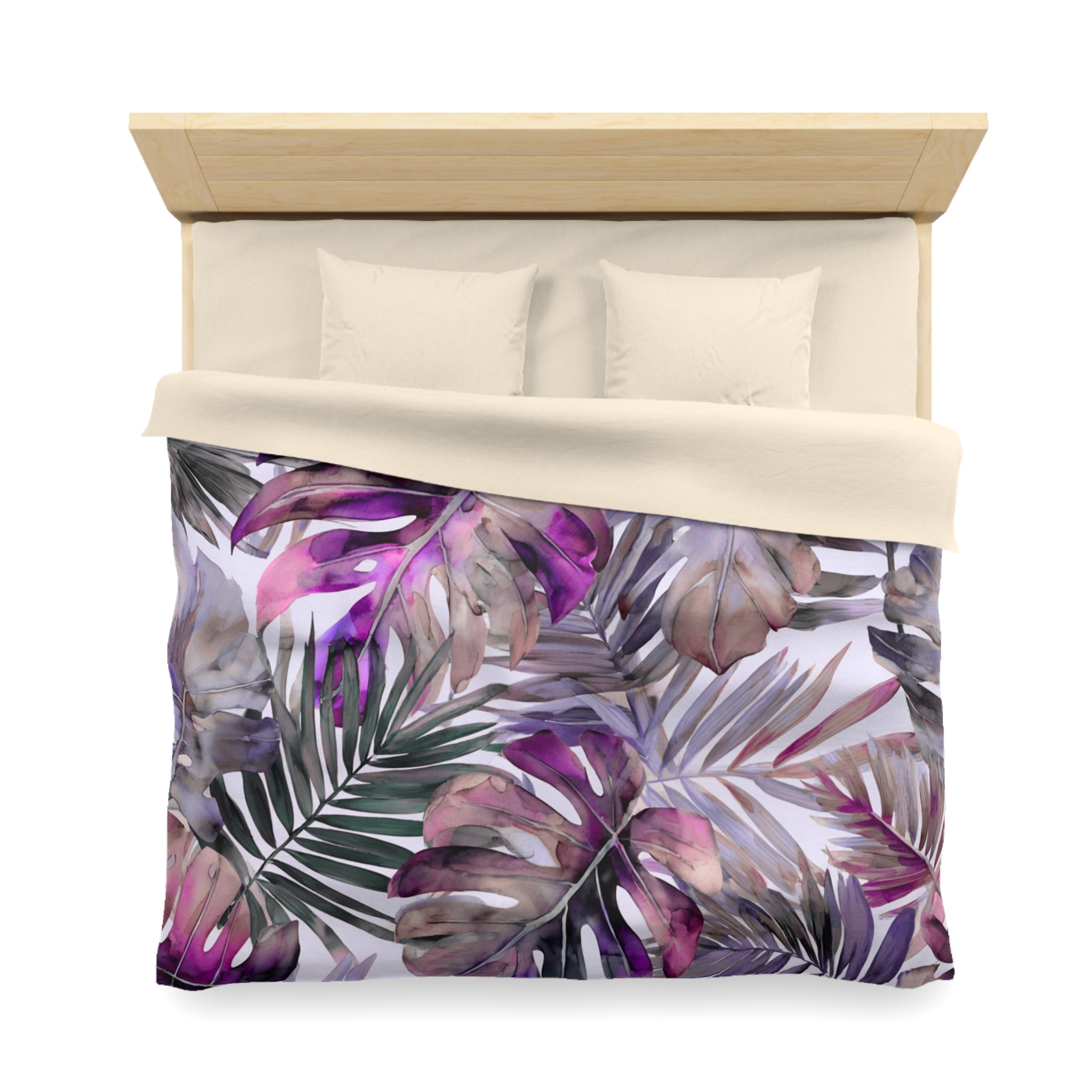 a bed with a colorful, tropical-themed bedspread featuring a pattern of purple and green leaves.