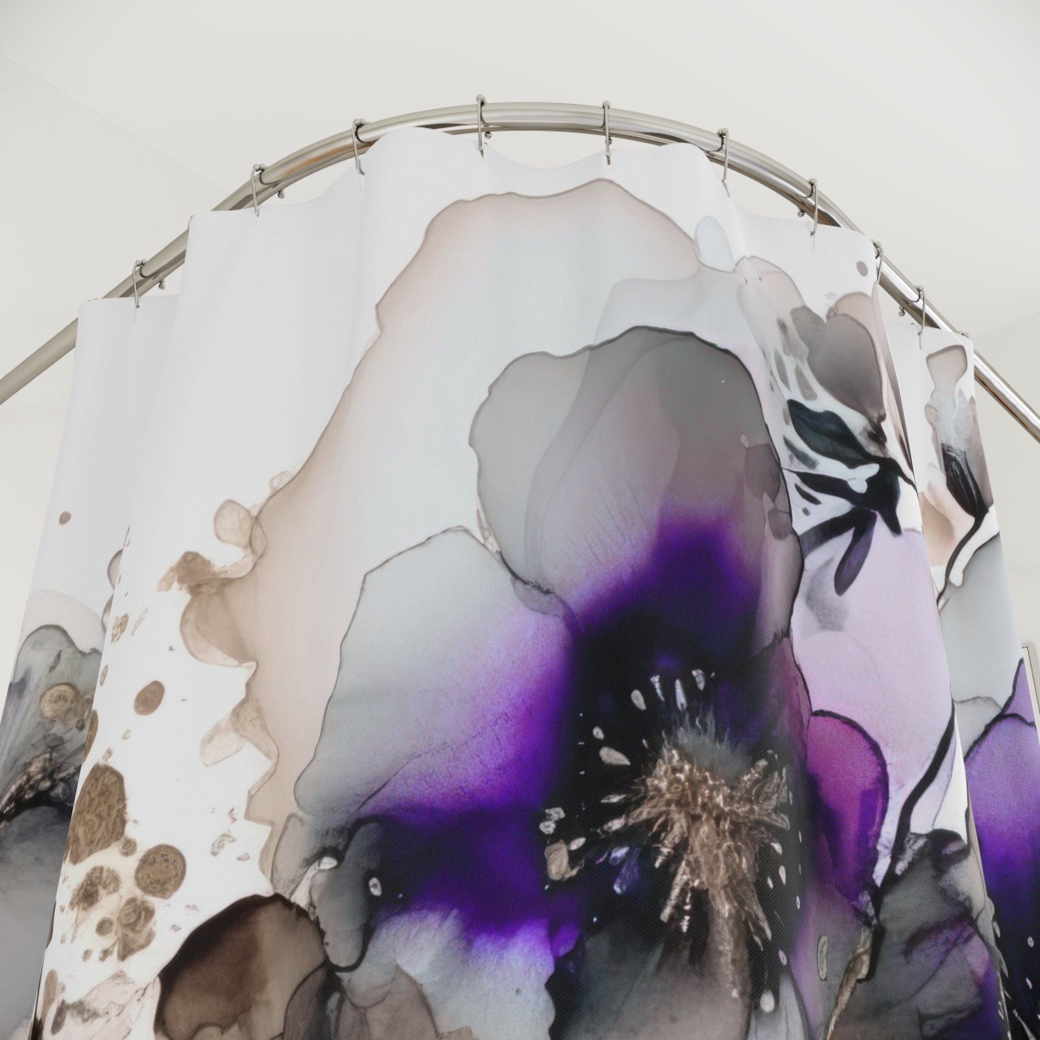 a shower curtain with a large, abstract floral design in shades of purple and gray.