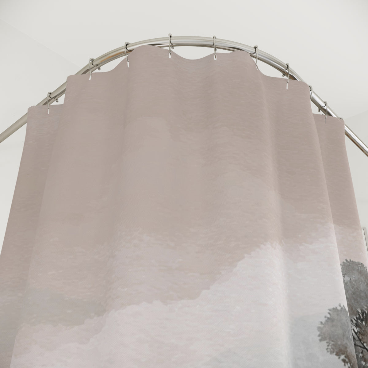 a shower curtain with a cloud-like pattern, hanging from a curved metal rod.
