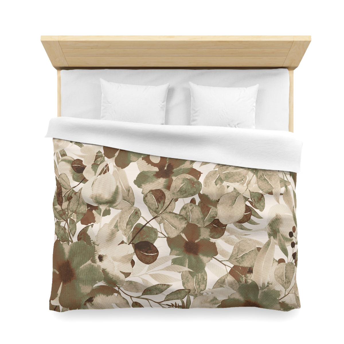a neatly made bed with a floral print comforter and two white pillows.
