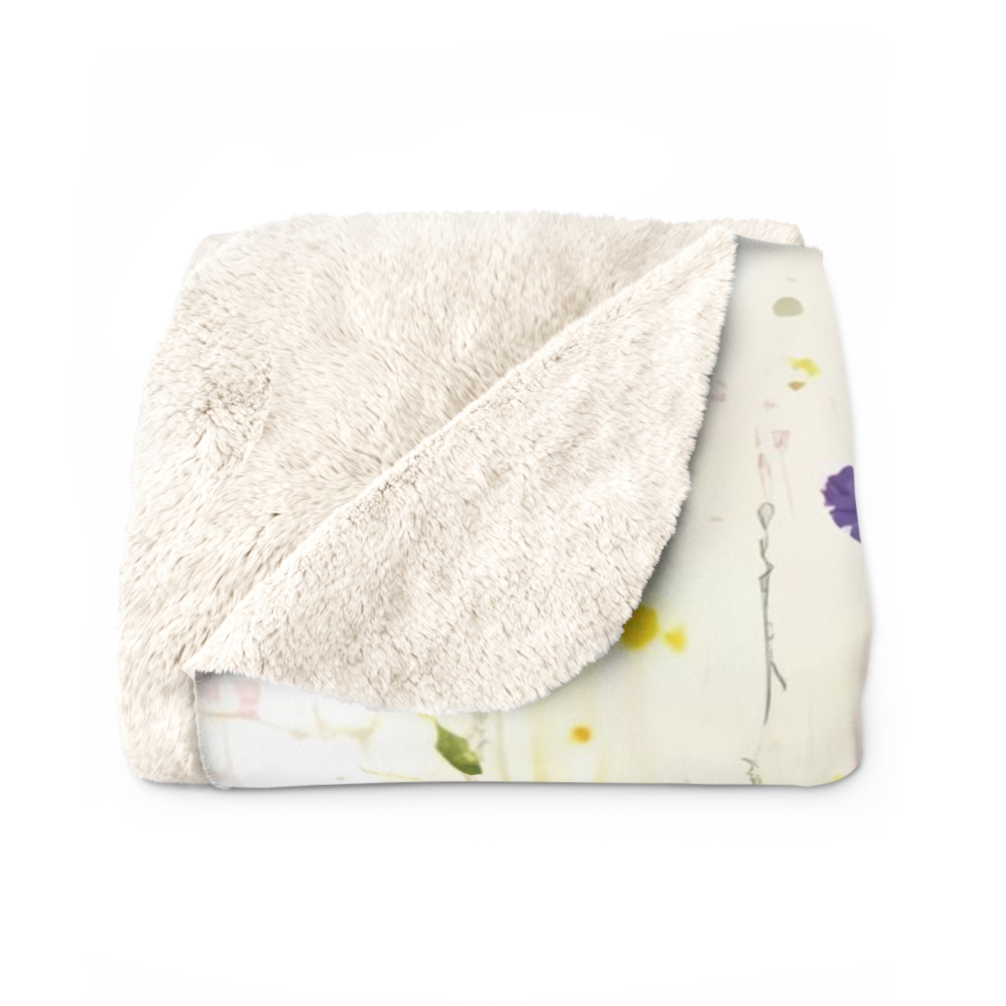 a white, fluffy, and soft-looking blanket or throw with a colorful abstract pattern on it.