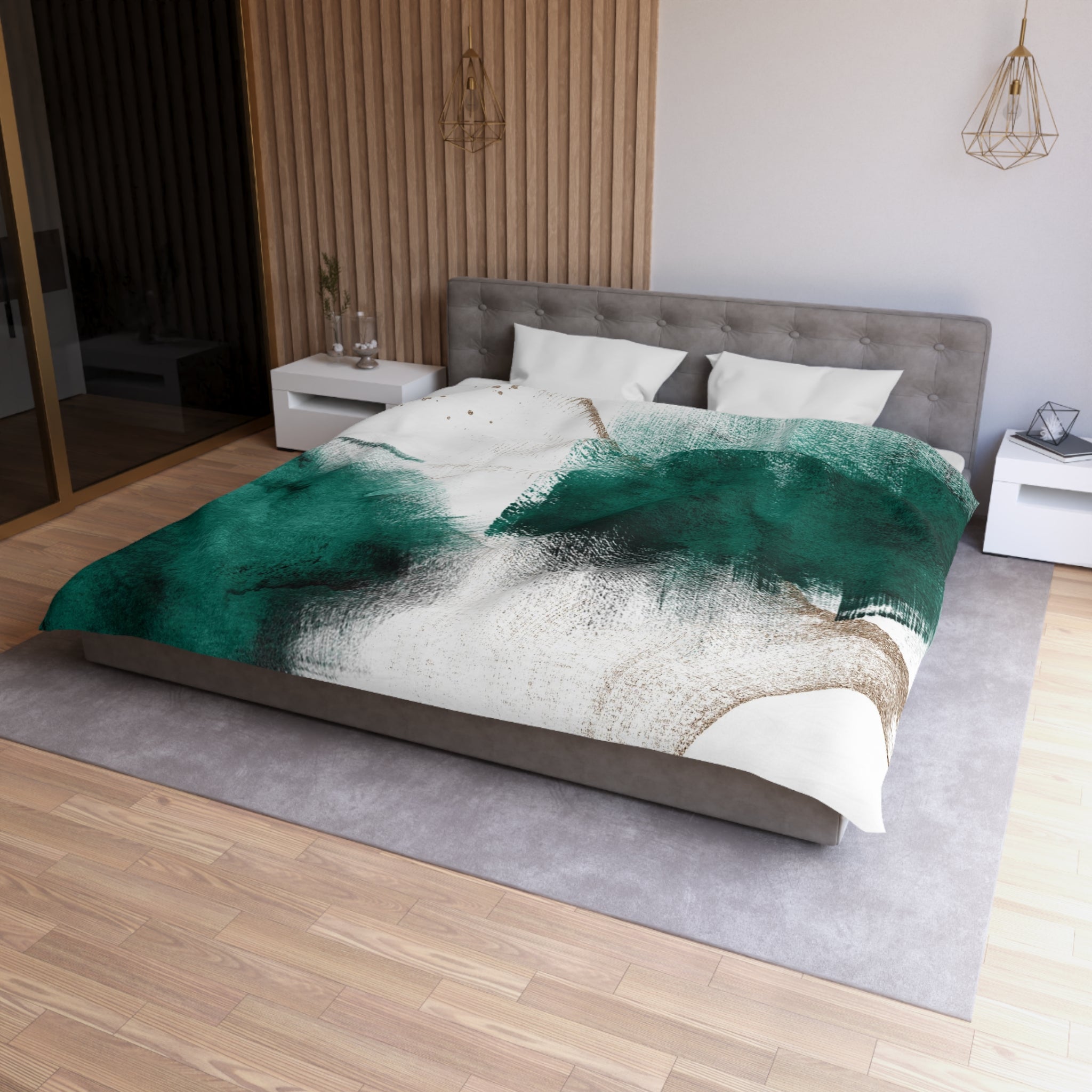a modern bedroom with a large bed, a gray headboard, and a green and white abstract patterned comforter. The room has a wooden floor and white walls, creating a serene and stylish atmosphere.